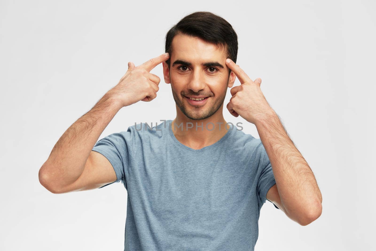 Cheerful man in blue t-shirts gesture hands emotion isolated background. High quality photo