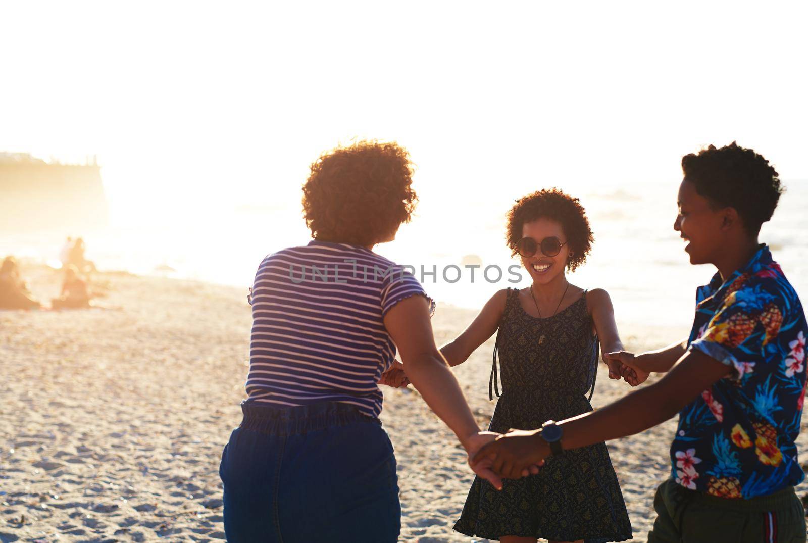 Friends make the world a better place. Cropped shot of an attractive young trio of women enjoying a day out together on the beach during the day. by YuriArcurs