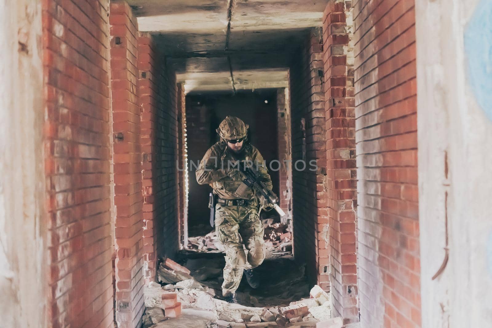 A bearded soldier in uniform of special forces in a dangerous military action in a dangerous enemy area. Selective focus by dotshock