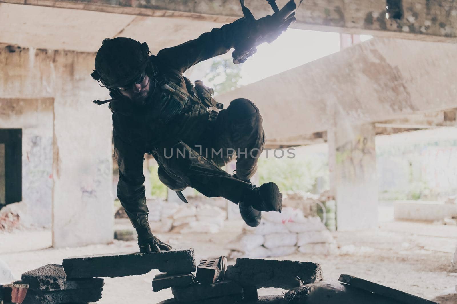 A bearded soldier in uniform of special forces in a dangerous military action in a dangerous enemy area. Selective focus by dotshock