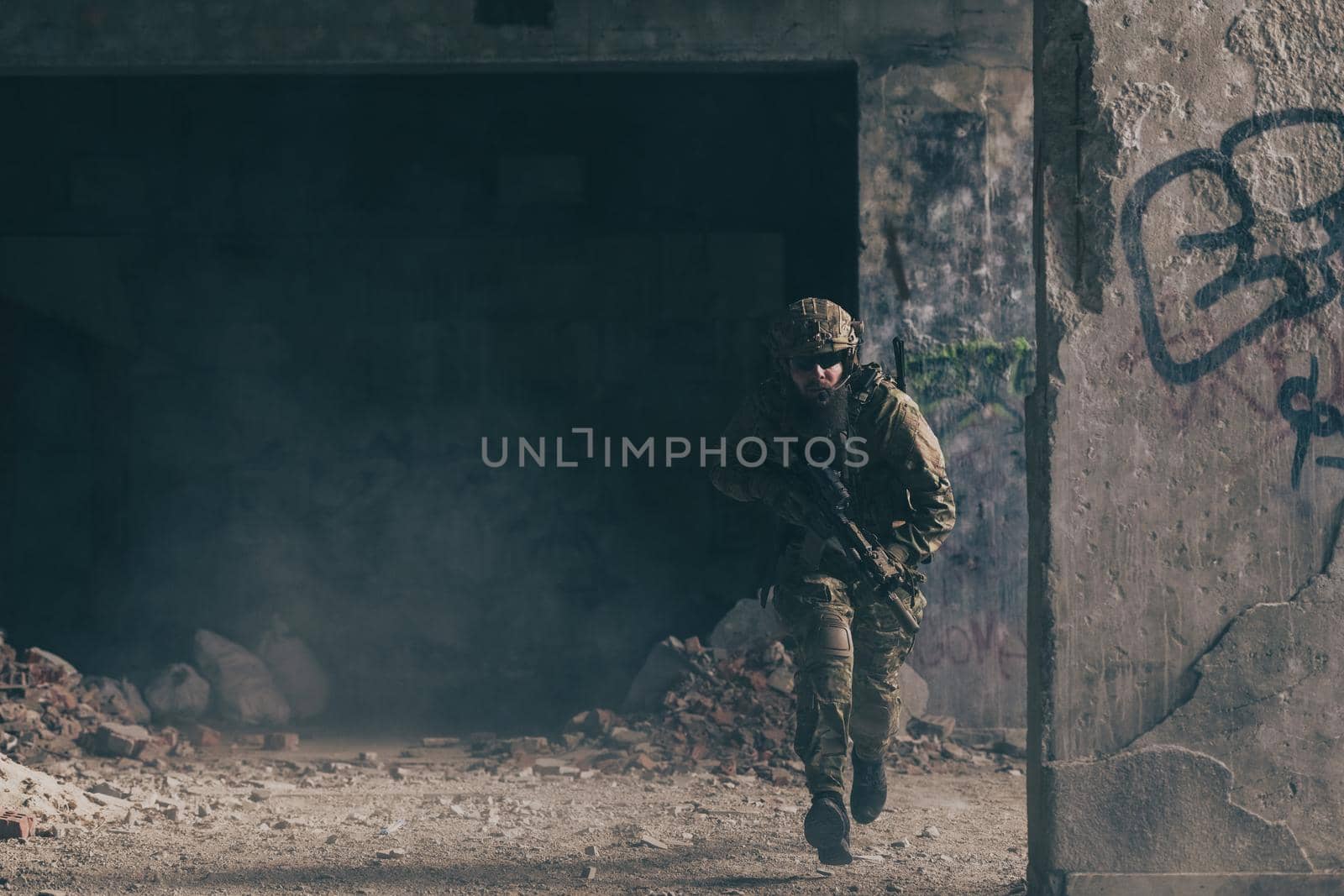 A bearded soldier in the uniform of special forces in dangerous military action in a dangerous enemy area. Selective focus. High-quality photo