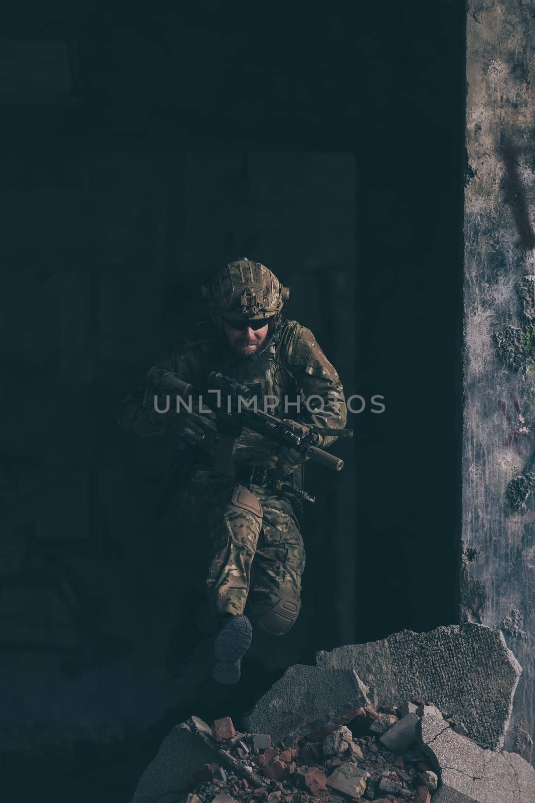 A bearded soldier in the uniform of special forces in dangerous military action in a dangerous enemy area. Selective focus. High-quality photo