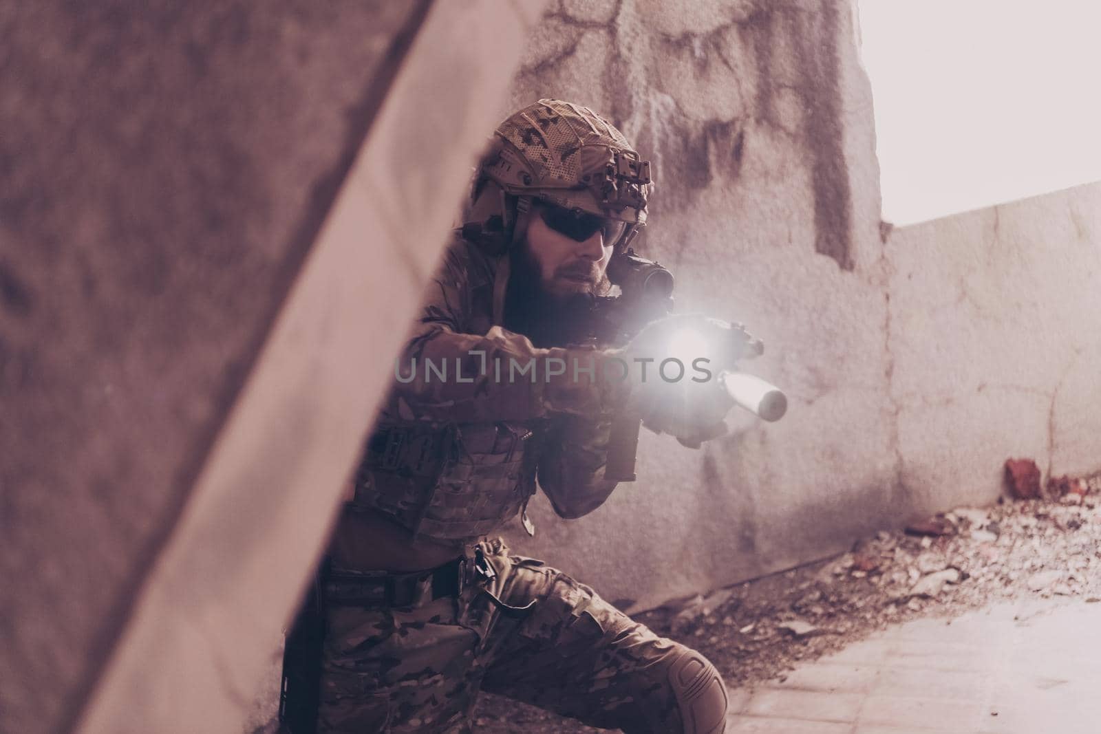 A bearded soldier in uniform of special forces in a dangerous military action in a dangerous enemy area. Selective focus by dotshock