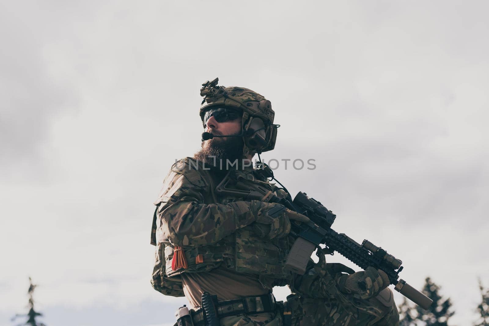 War concept. A bearded soldier in a special forces uniform fighting an enemy in a forest area. Selective focus. High-quality photo