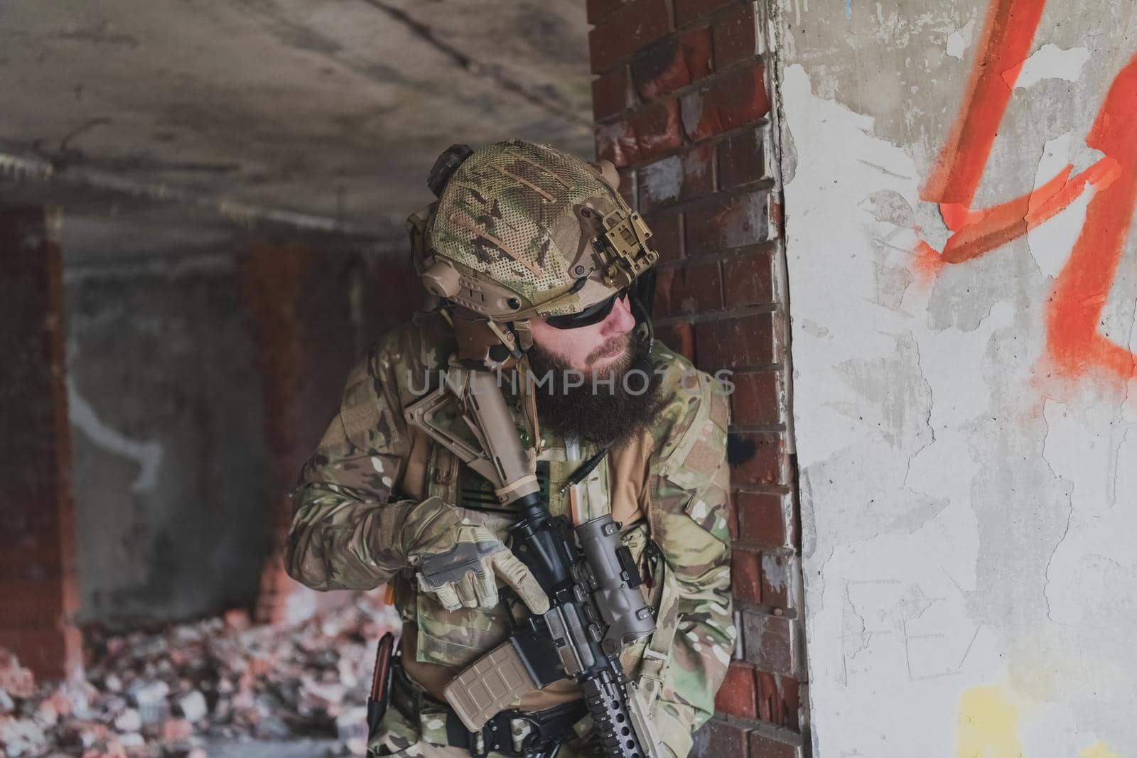 A bearded soldier in the uniform of special forces in dangerous military action in a dangerous enemy area. Selective focus. High-quality photo