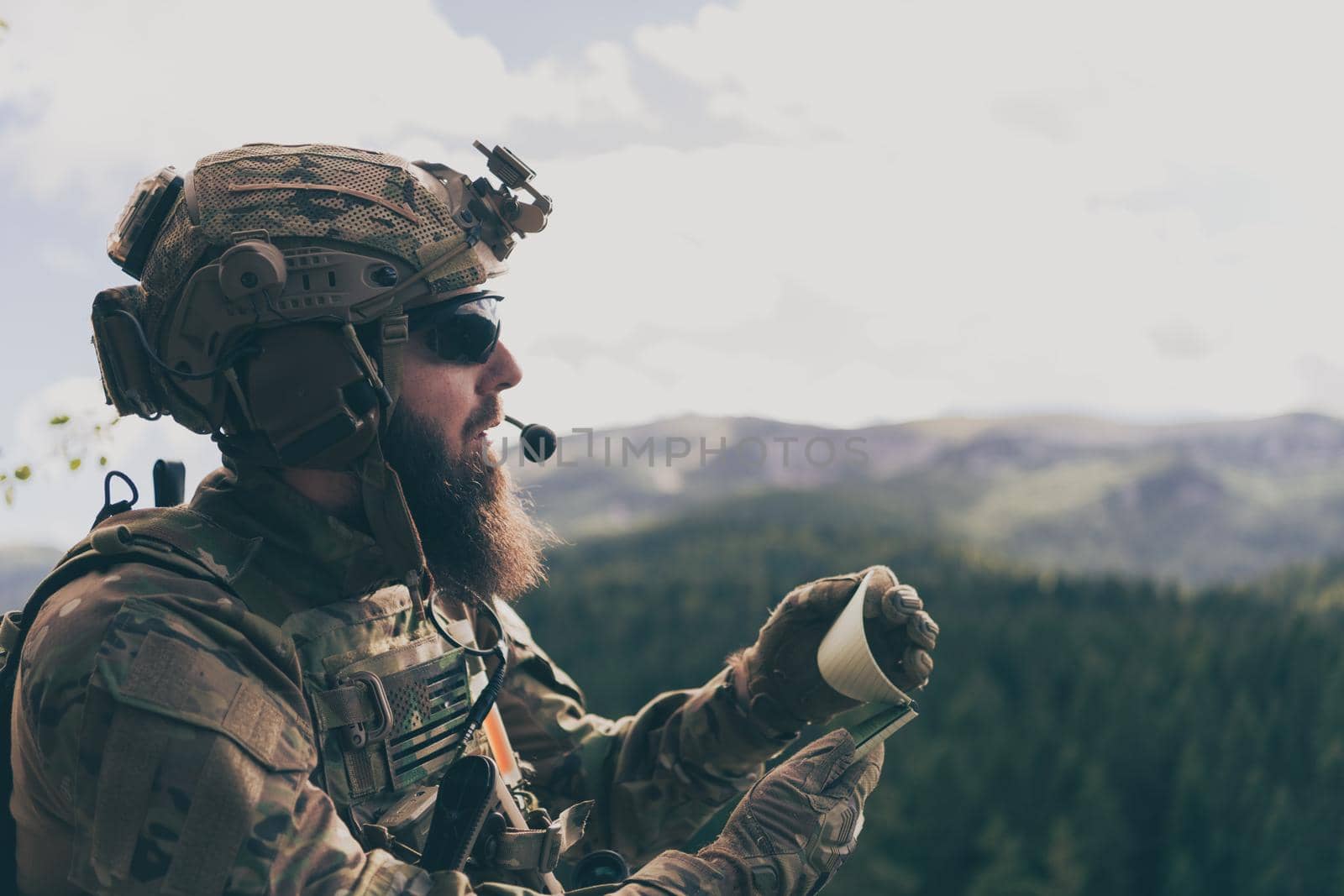 War concept. Bearded soldier in uniform of special forces in dangerous military action in dangerous enemy area studies attack tactics. Selective focus. High-quality photo