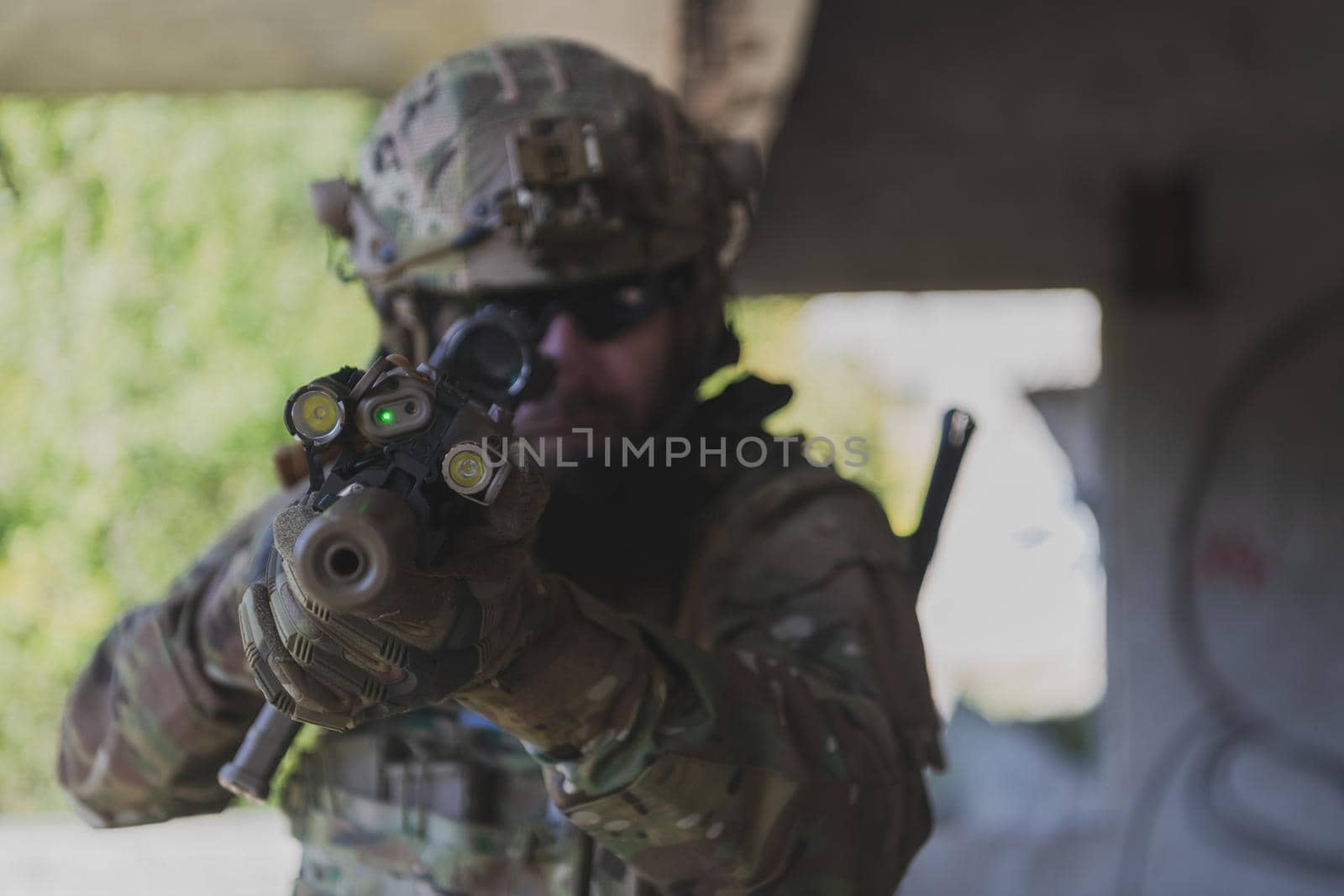 A bearded soldier in the uniform of special forces in dangerous military action in a dangerous enemy area. Selective focus. High-quality photo