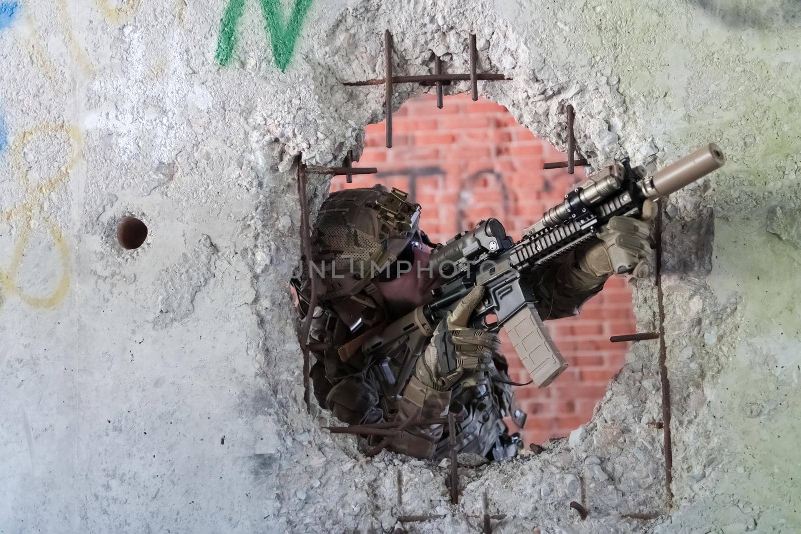 A bearded soldier in uniform of special forces in a dangerous military action in a dangerous enemy area. Selective focus by dotshock