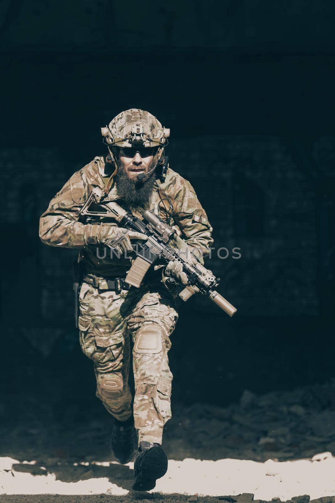 A bearded soldier in the uniform of special forces in dangerous military action in a dangerous enemy area. Selective focus. High-quality photo