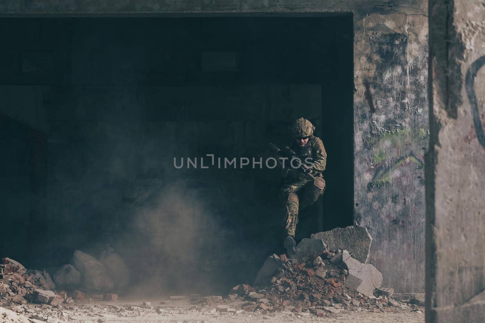 A bearded soldier in uniform of special forces in a dangerous military action in a dangerous enemy area. Selective focus by dotshock