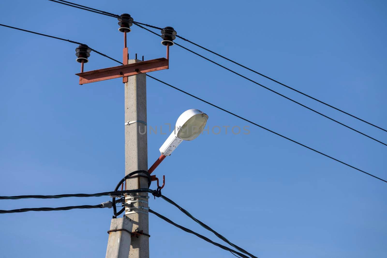 Street lantern against blue sky. City lamp