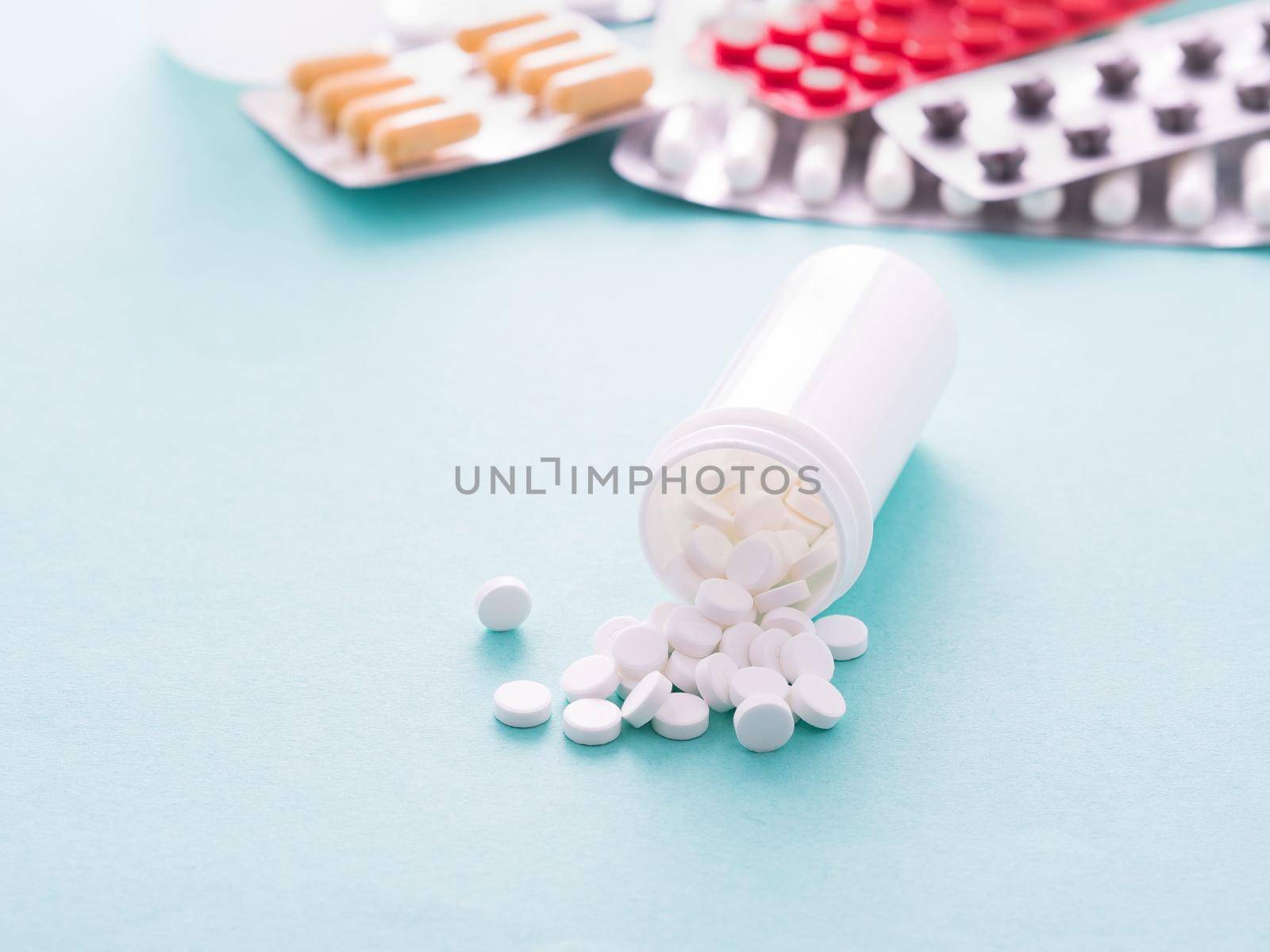 medicine bottles and pills on blue background