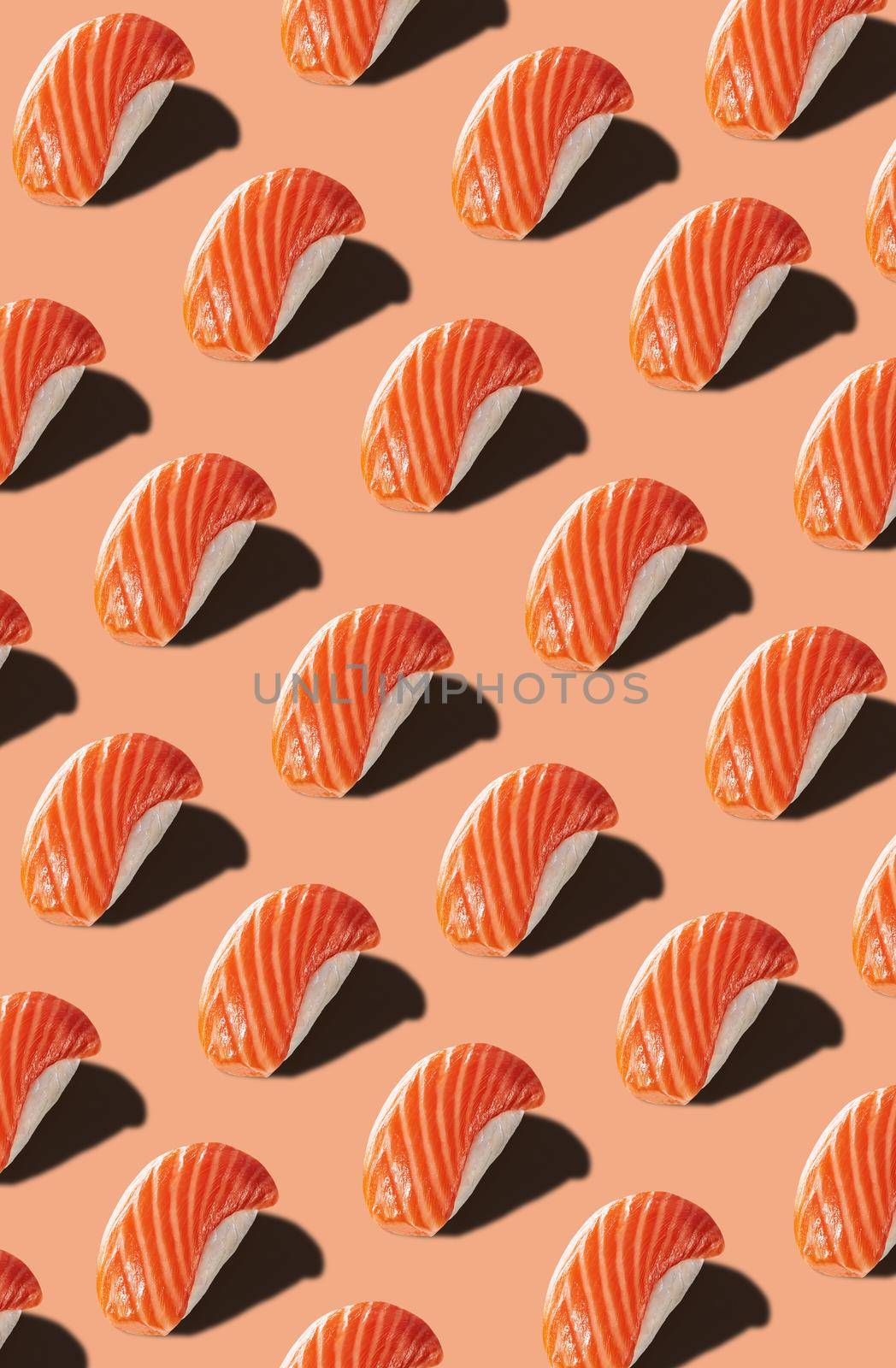Food pattern of nigirizushi with salmon on pinkish background by nazarovsergey