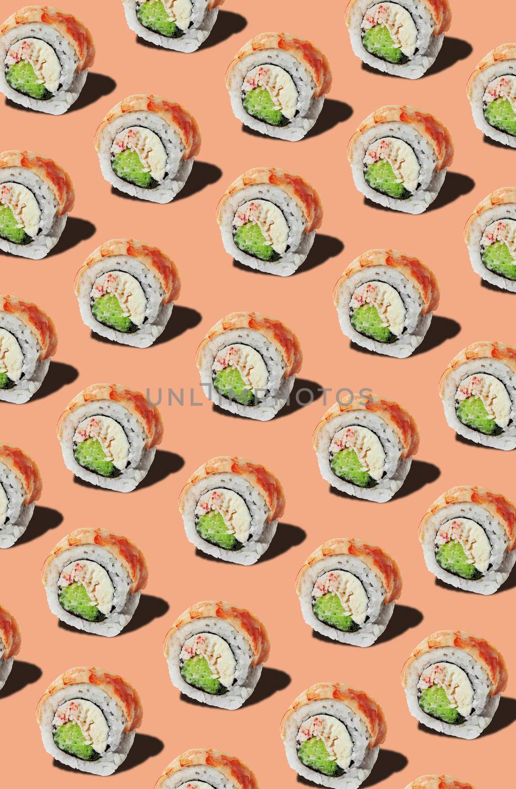 Rolls with tiger prawn fillet stuffed with cream cheese, crab surimi and fresh cucumbers on pinkish orange background. Traditional Japanese food concept. Seamless food pattern