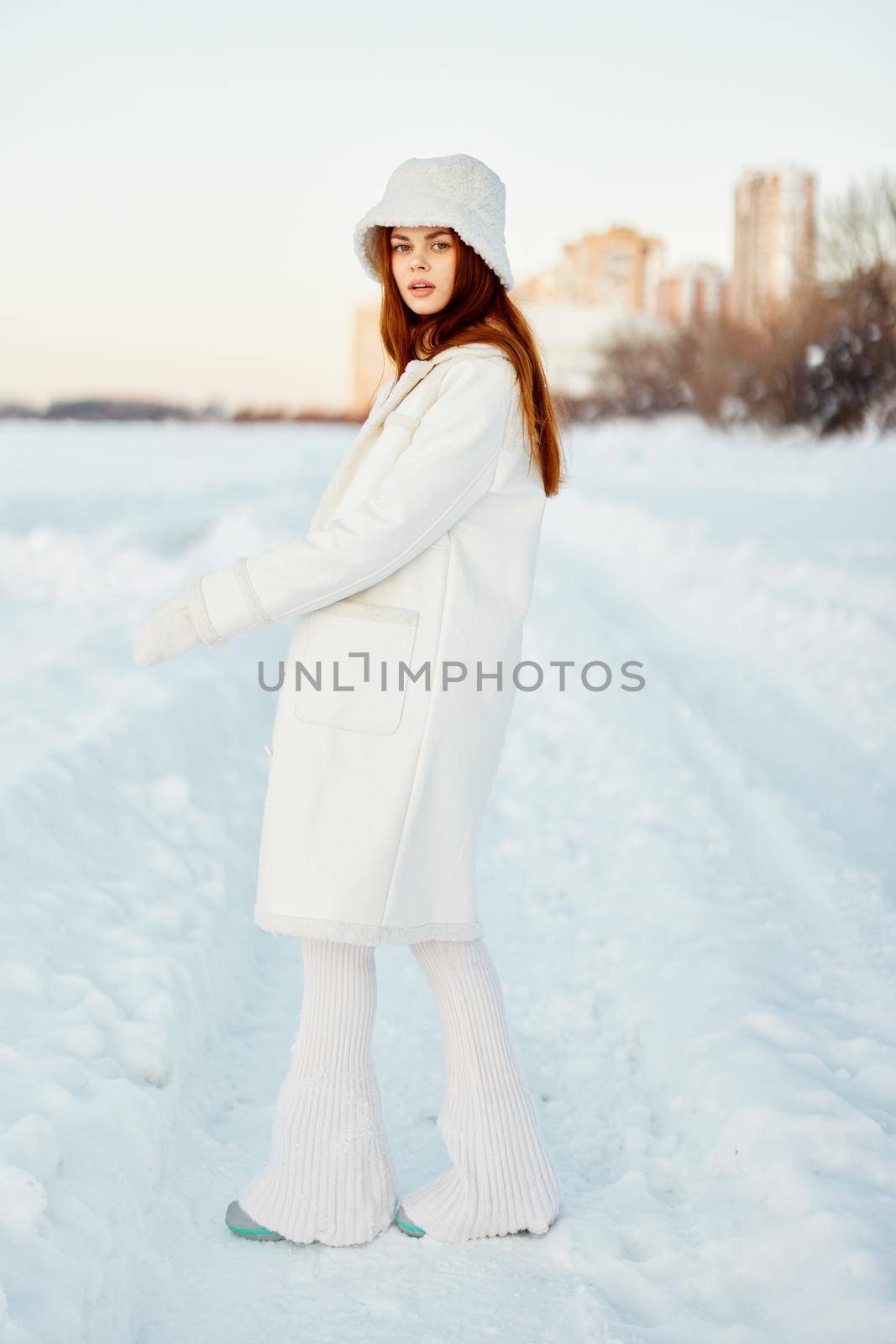 young woman in a white coat in a hat winter landscape walk Fresh air by SHOTPRIME