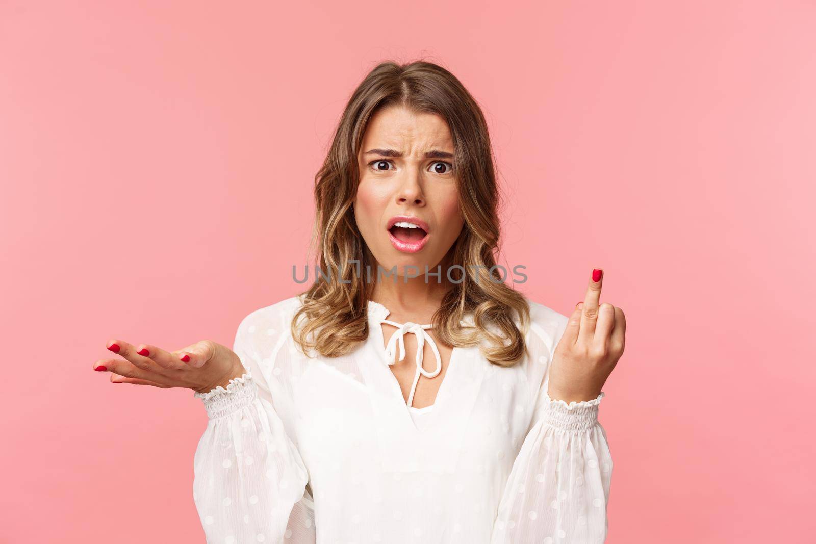 Close-up portrait of questioned and annoyed young woman tired of waiting for boyfriend making next step and do proposal, showing finger without ring, shrugging and complaining.