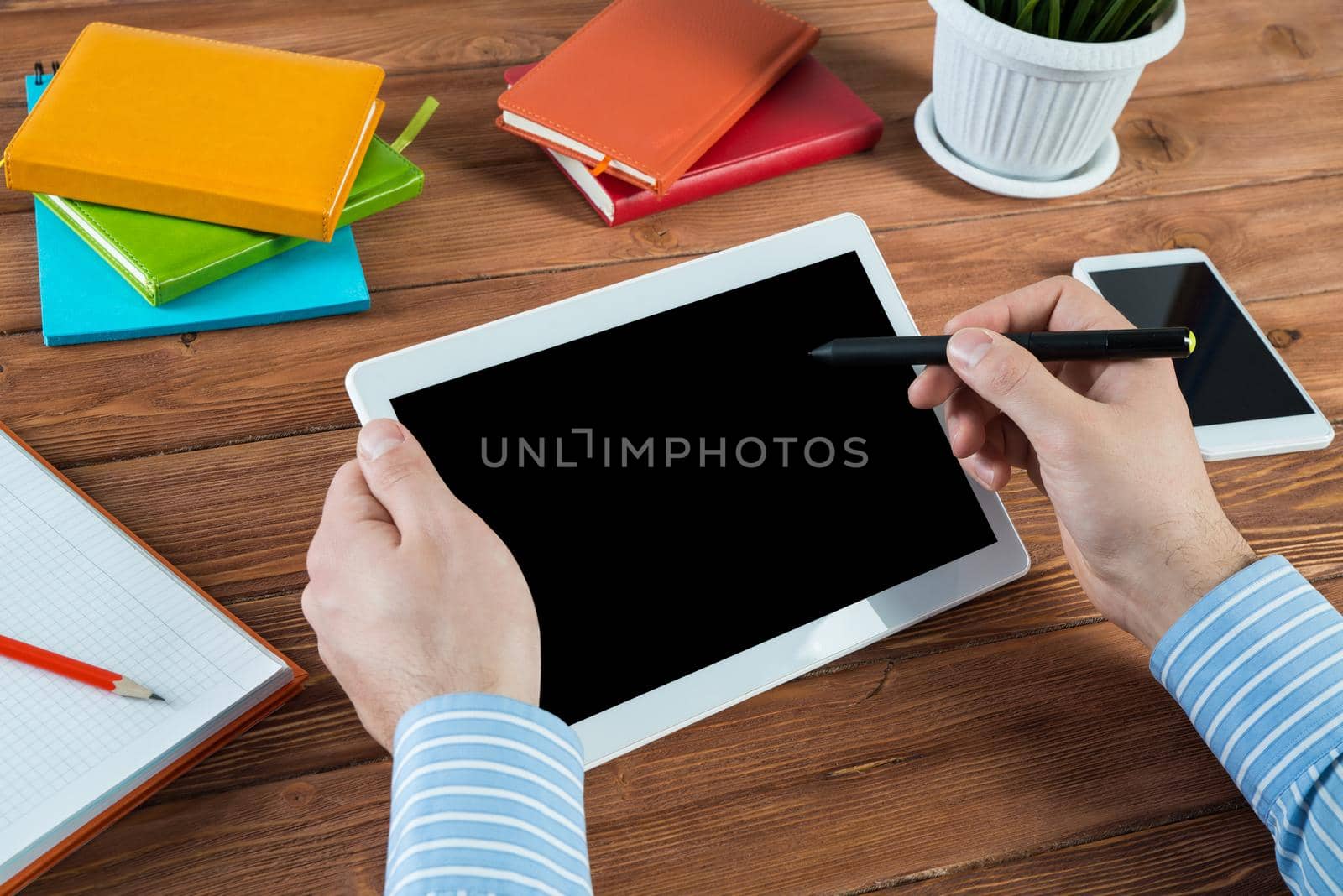 close-up of men's hands with a computer tablet. Businessman works in the office