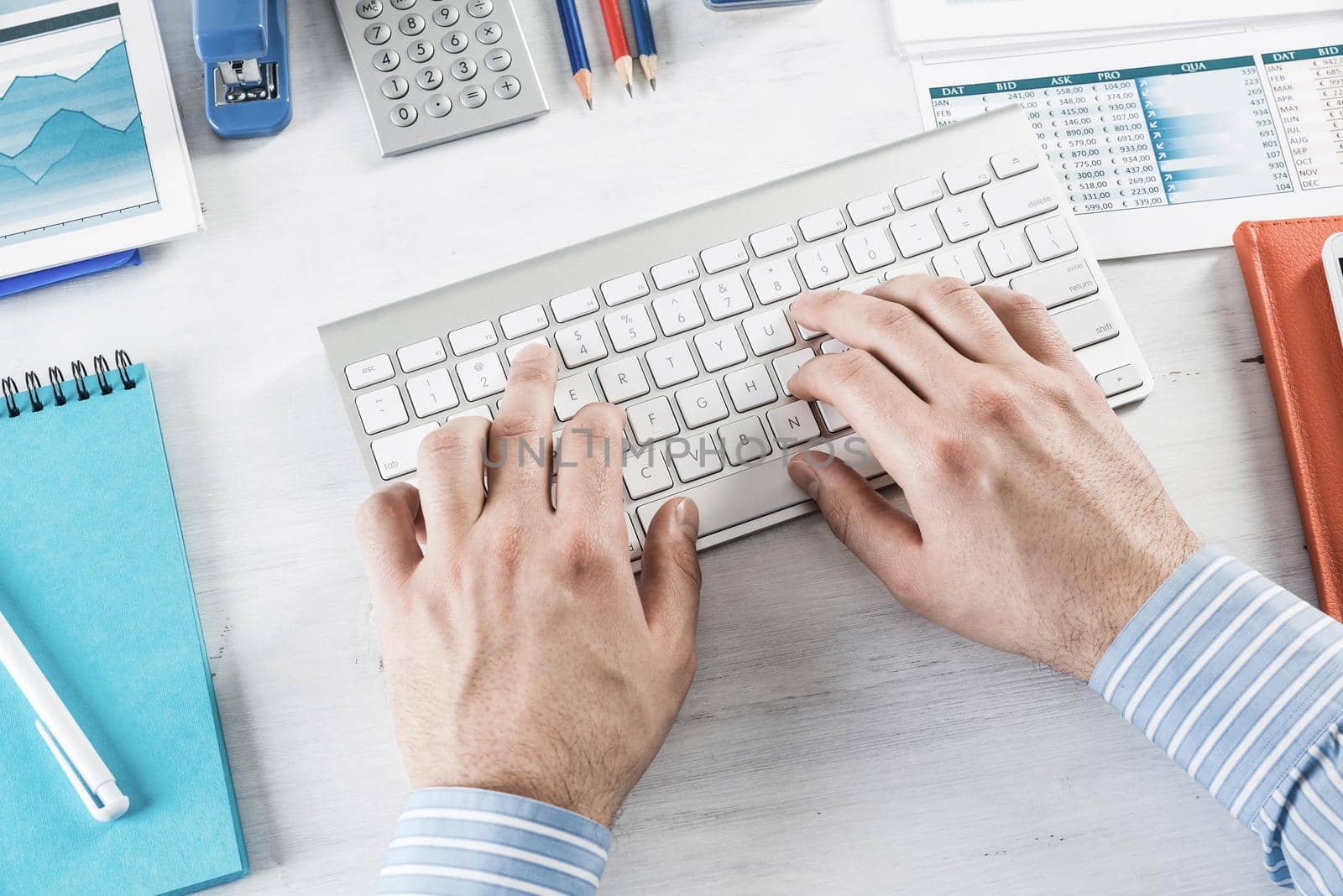 close-up men's hands type on the keyboard. office work