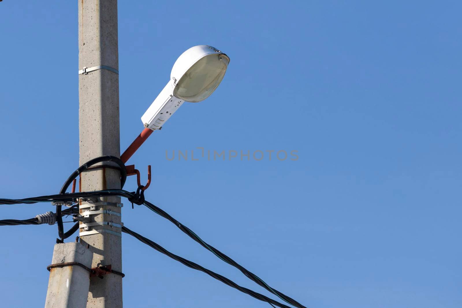 Street lantern against blue sky. City lamp