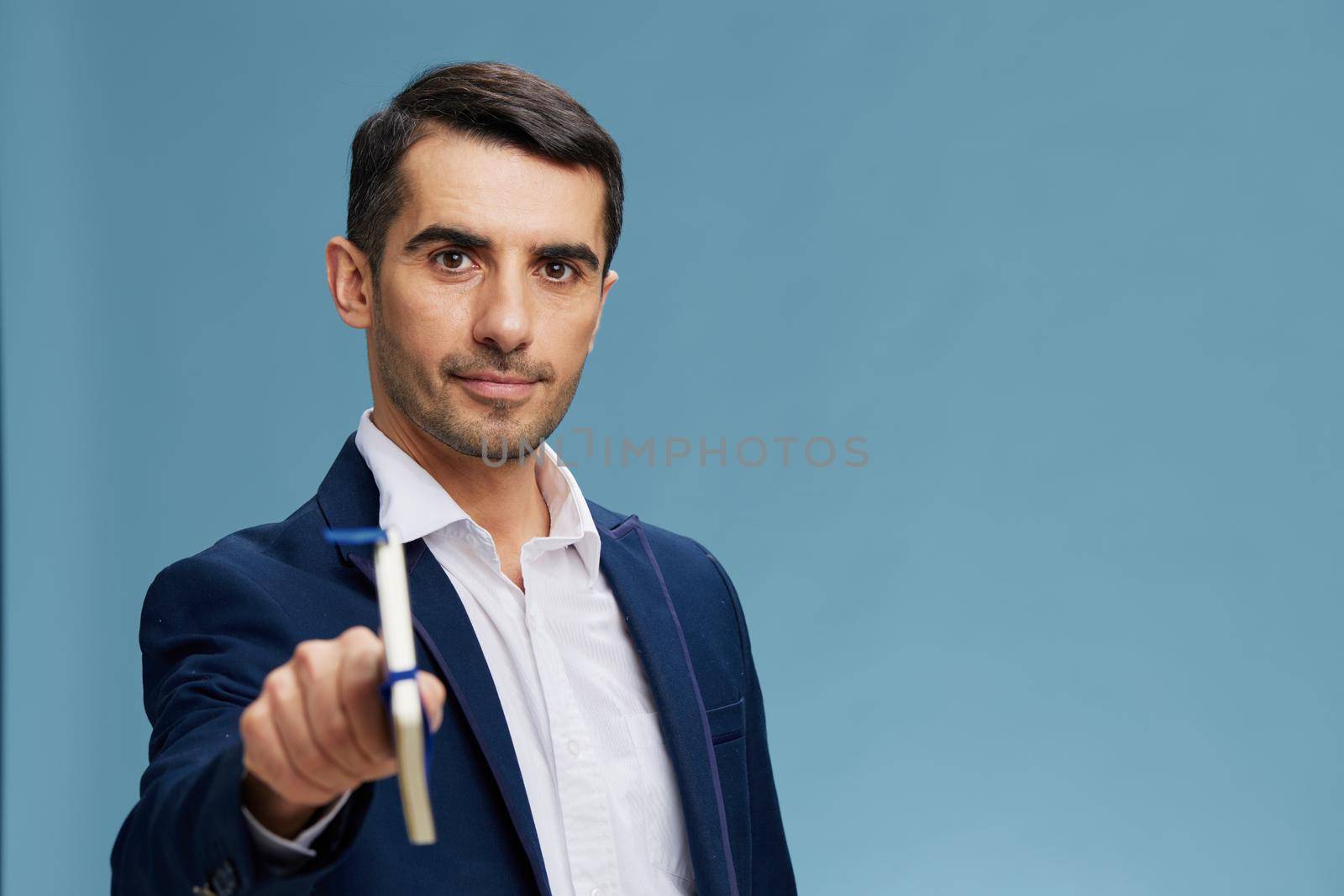 successful man with a notepad in hand financial management self-confidence blue background. High quality photo