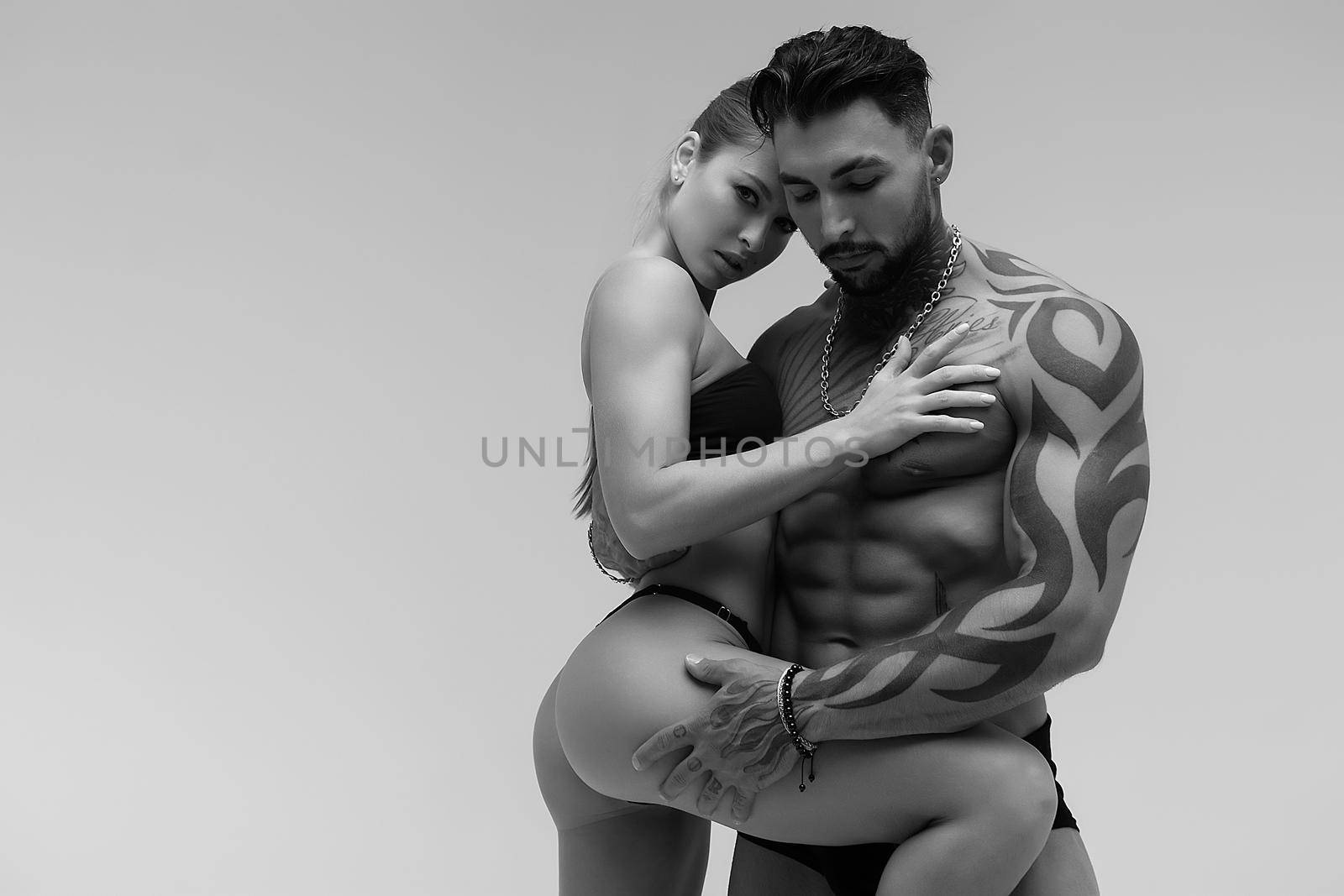 Sexy young couple in studio by 3KStudio