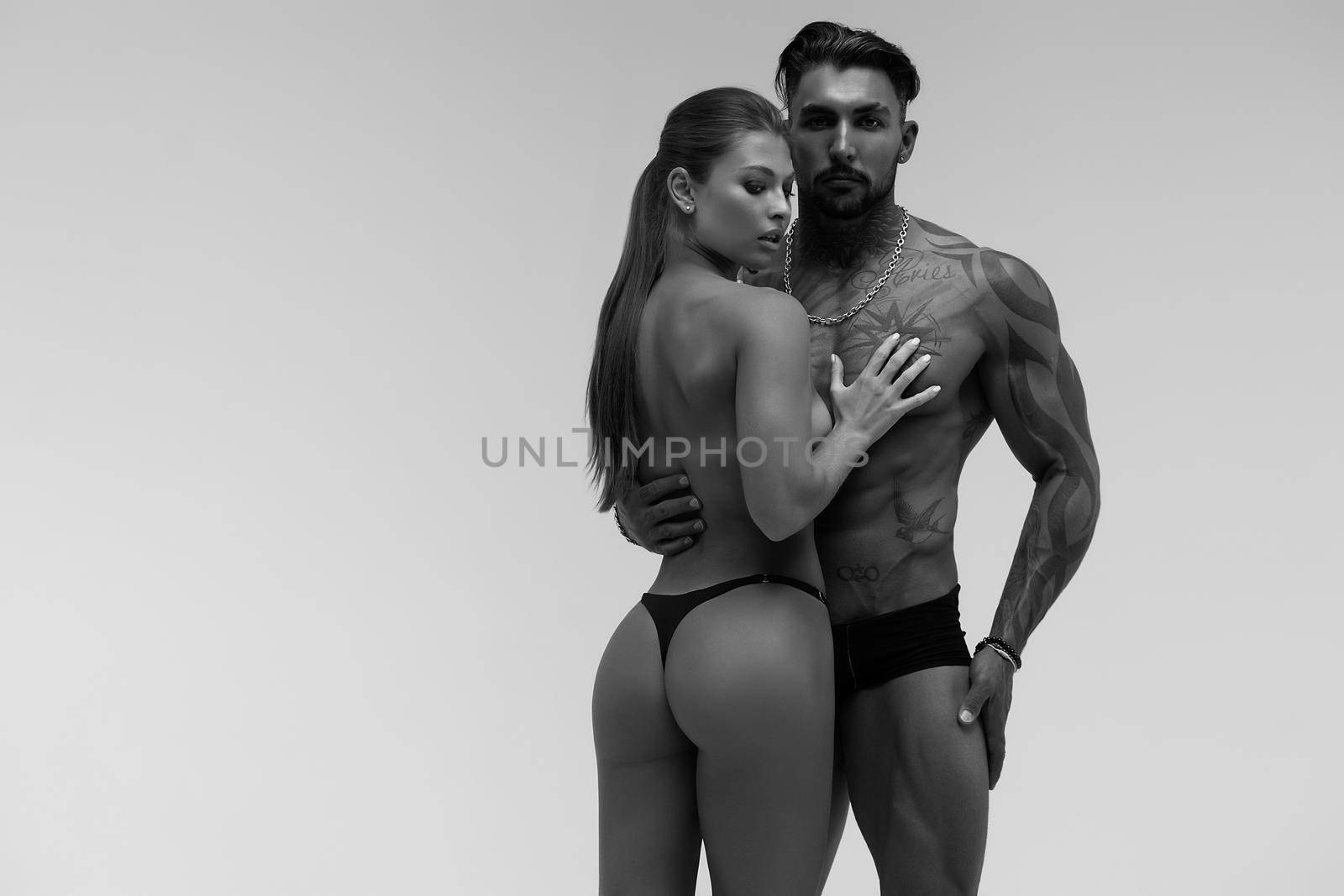 Sexy young couple in studio by 3KStudio