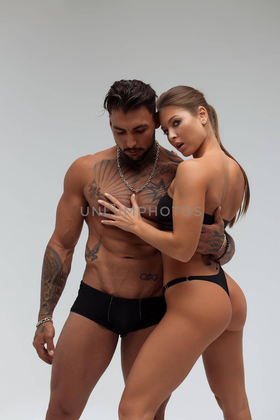 Woman hugging muscular man from behind by 3KStudio