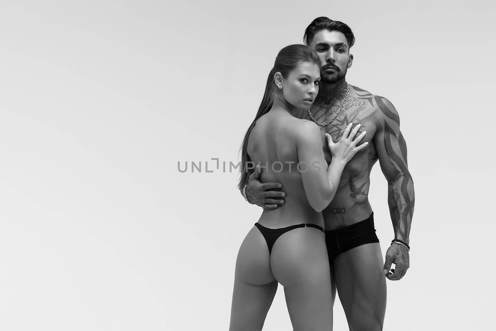 Sexy young couple in studio by 3KStudio