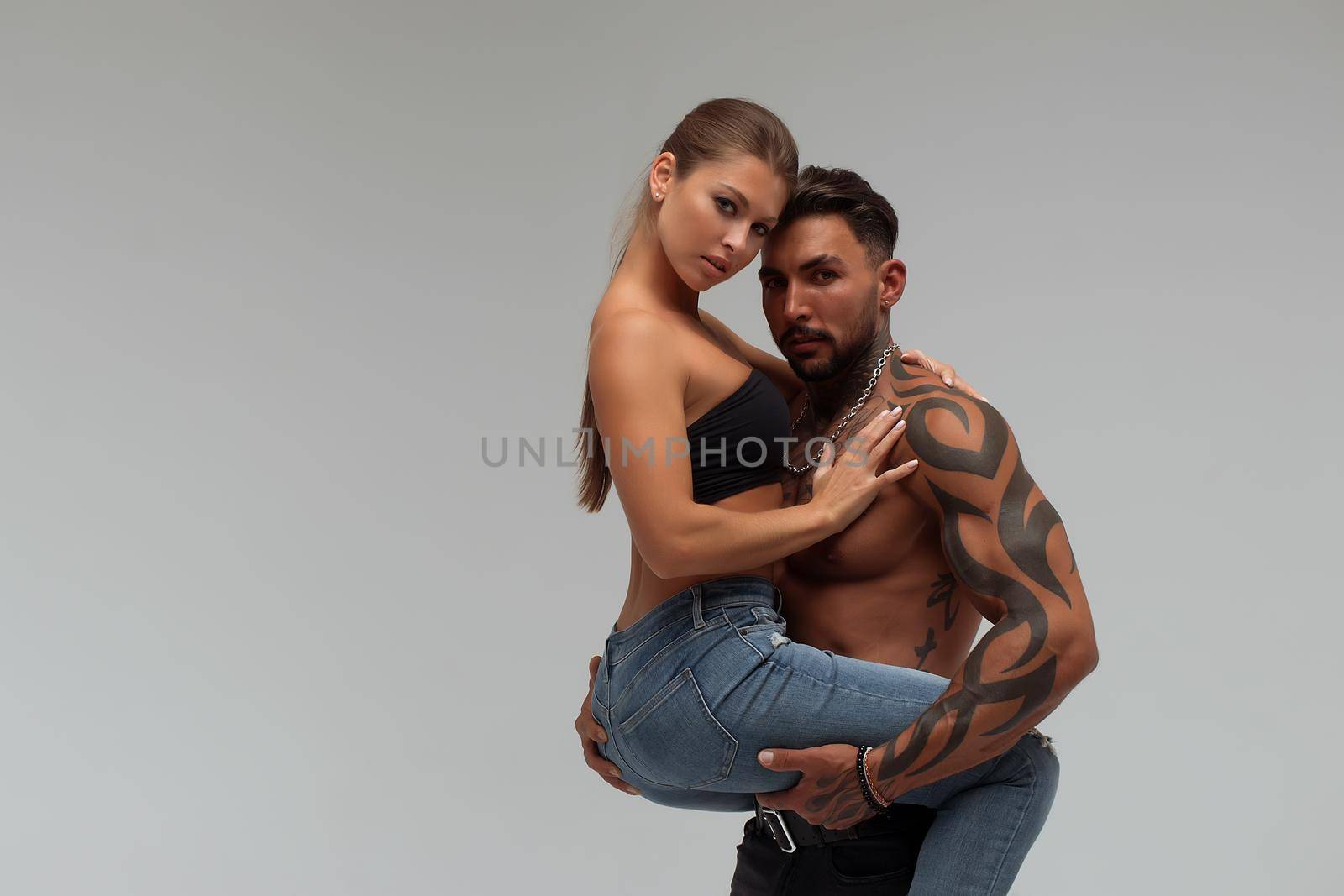 Muscular man hugging topless woman by 3KStudio