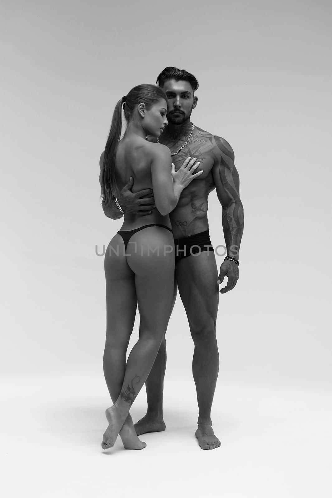 Sexy young couple in studio by 3KStudio