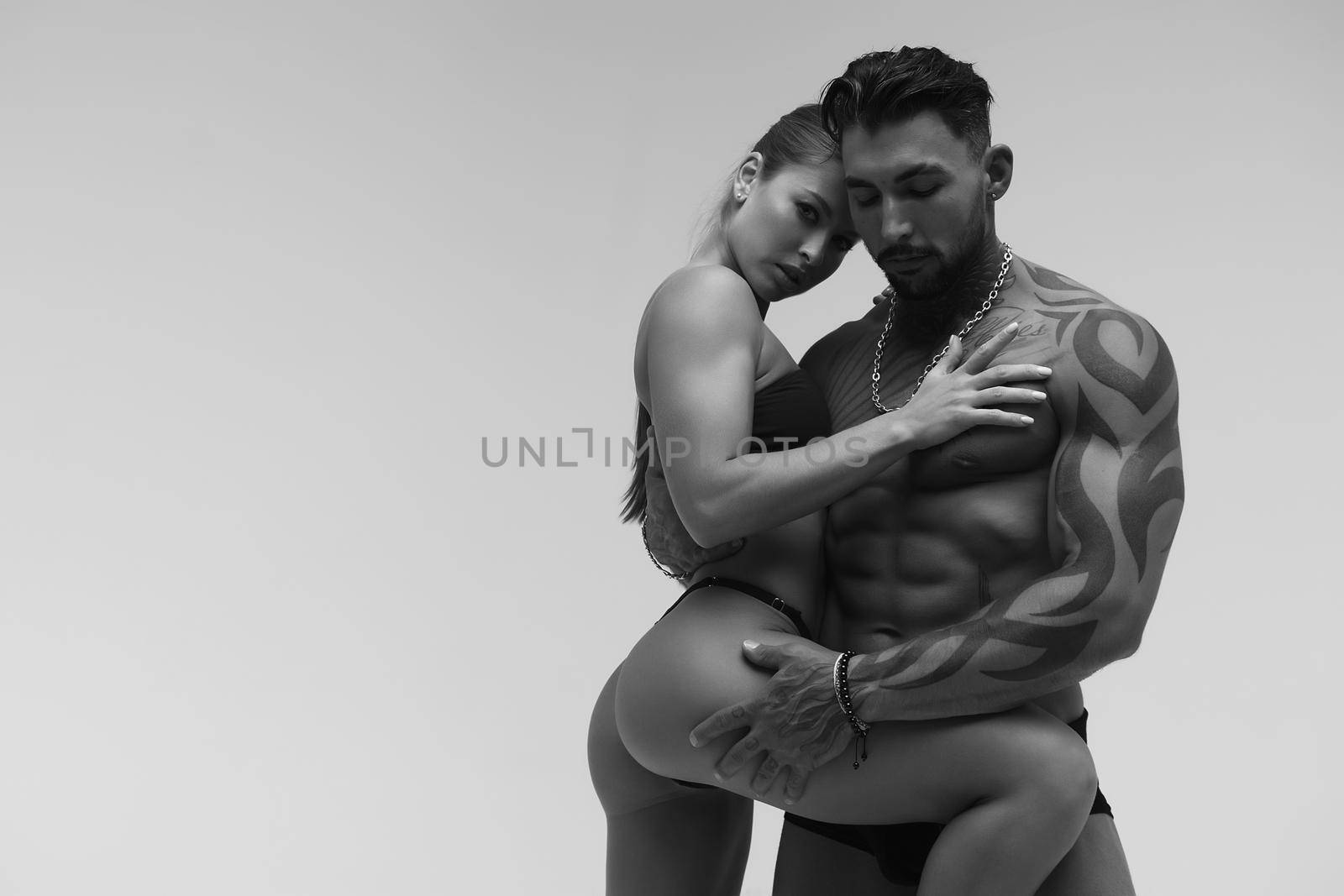 Sexy young couple in studio by 3KStudio