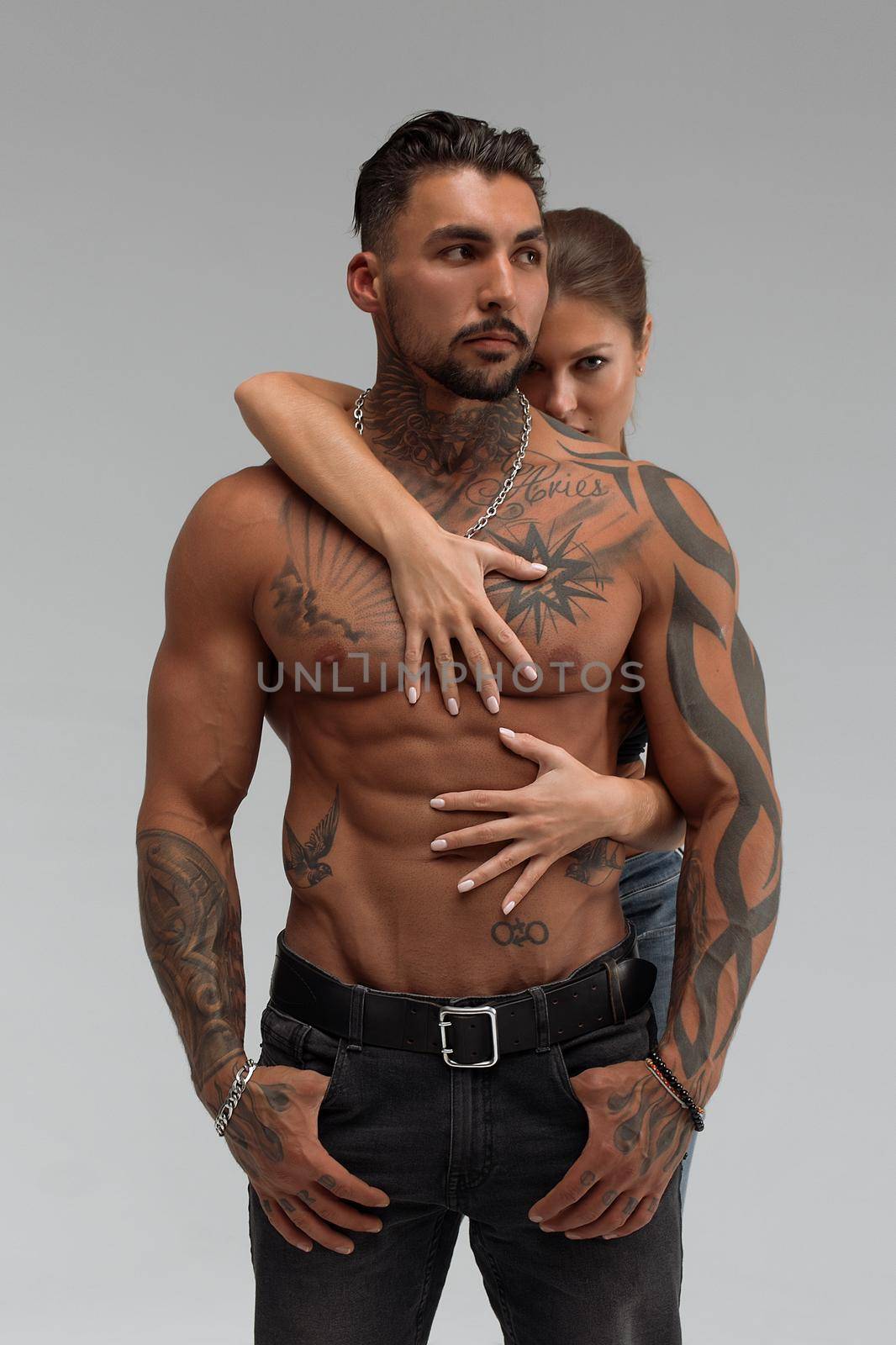 Woman hugging muscular man from behind by 3KStudio