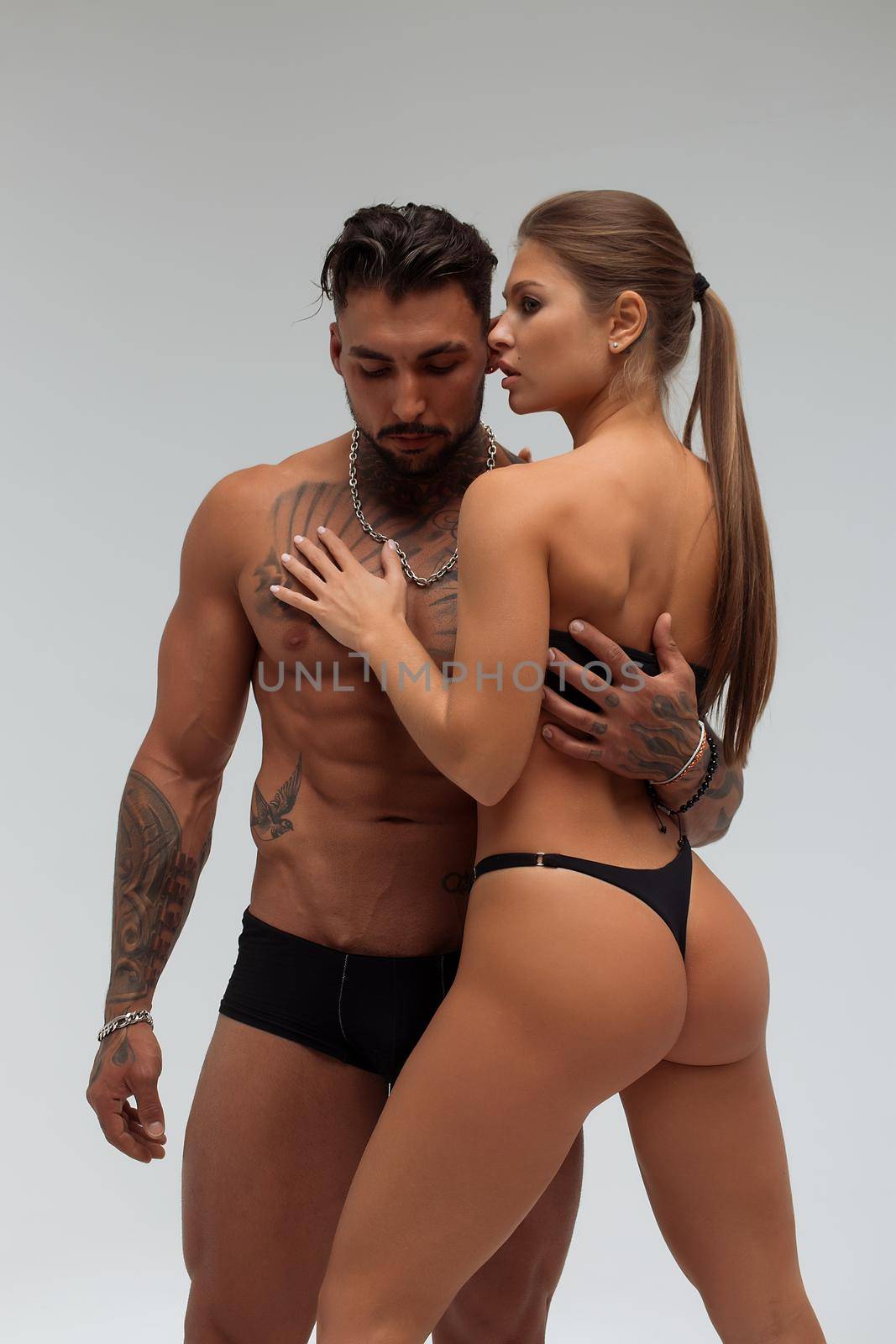 Woman hugging muscular man from behind by 3KStudio