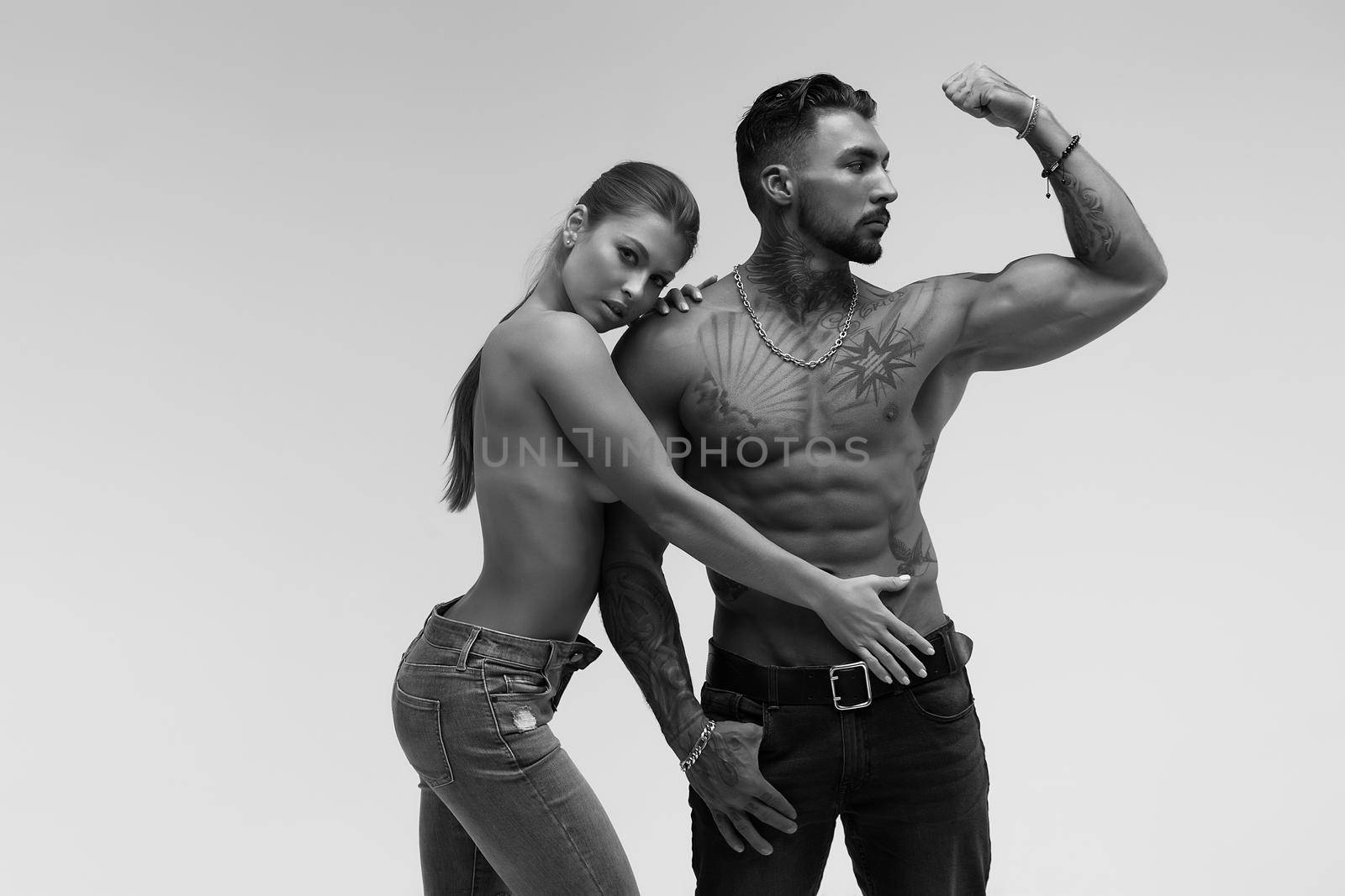 Sexy young couple in studio by 3KStudio