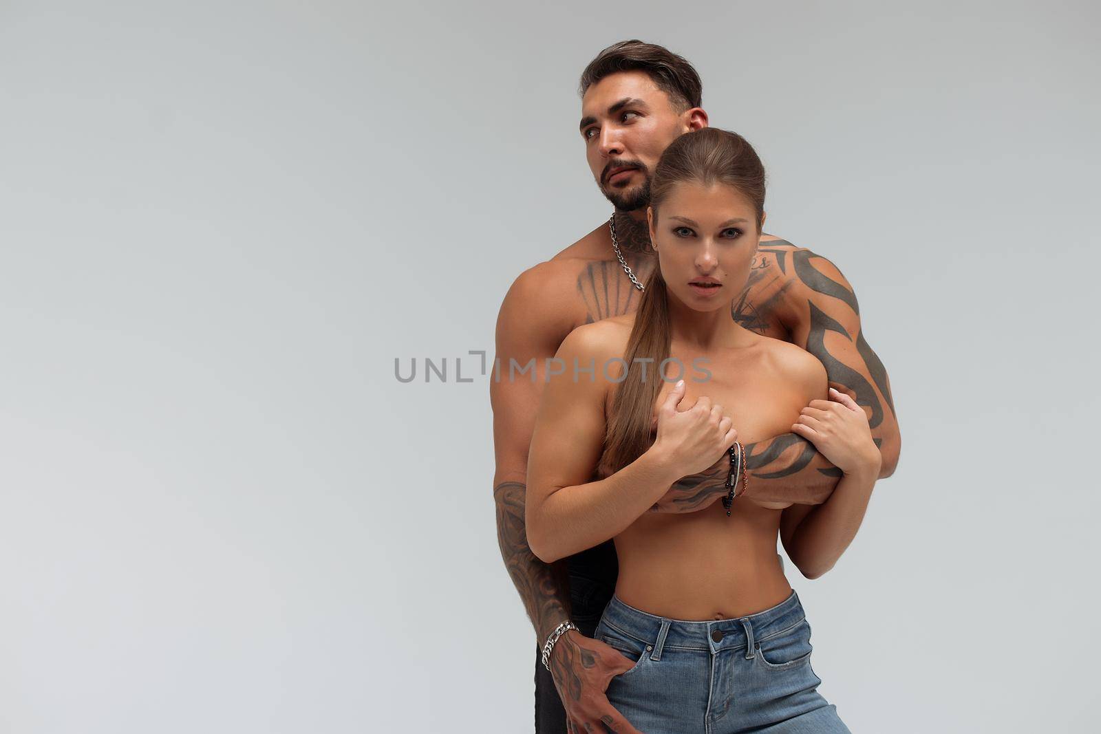 Muscular man hugging topless woman by 3KStudio