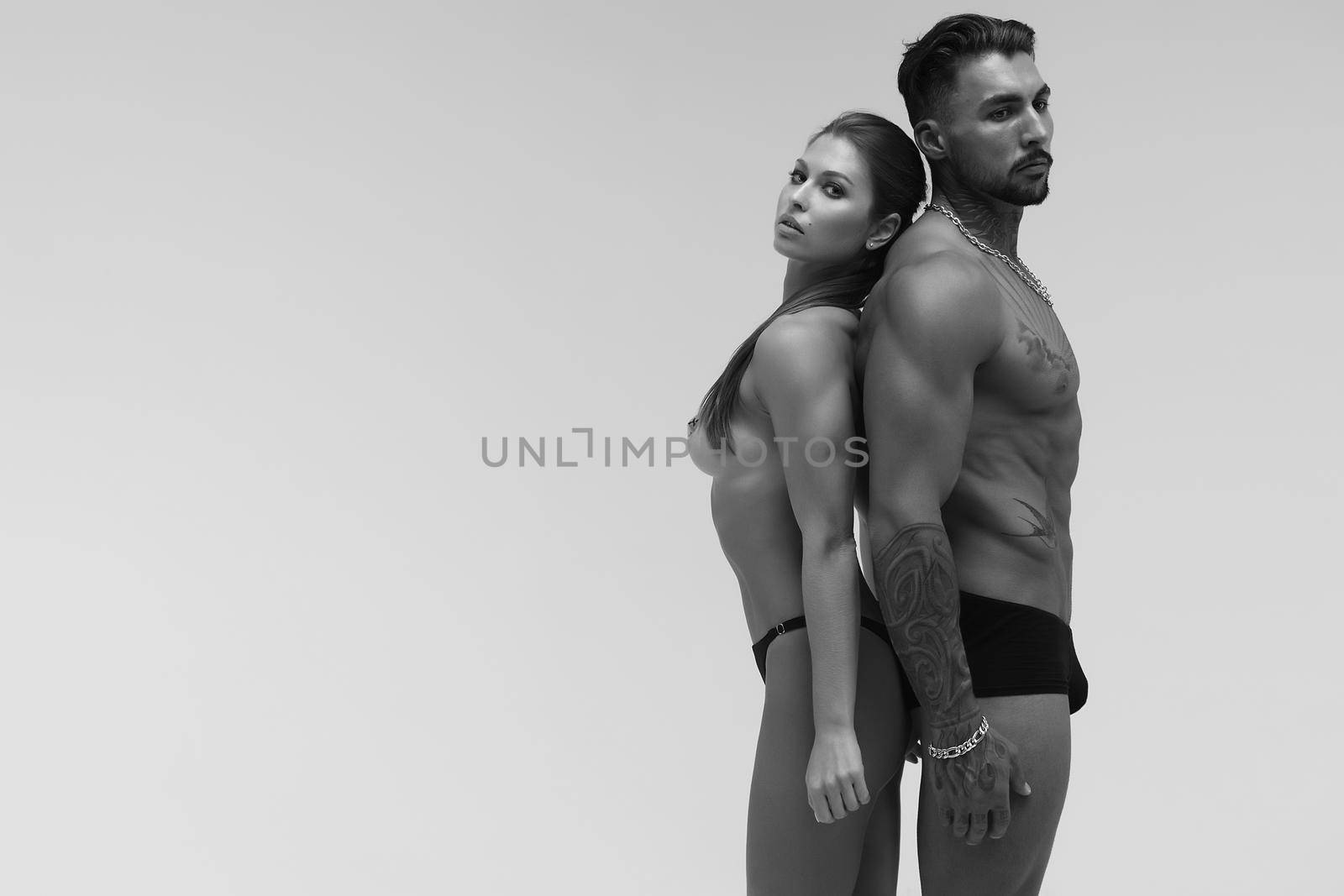 Sexy young couple in studio by 3KStudio