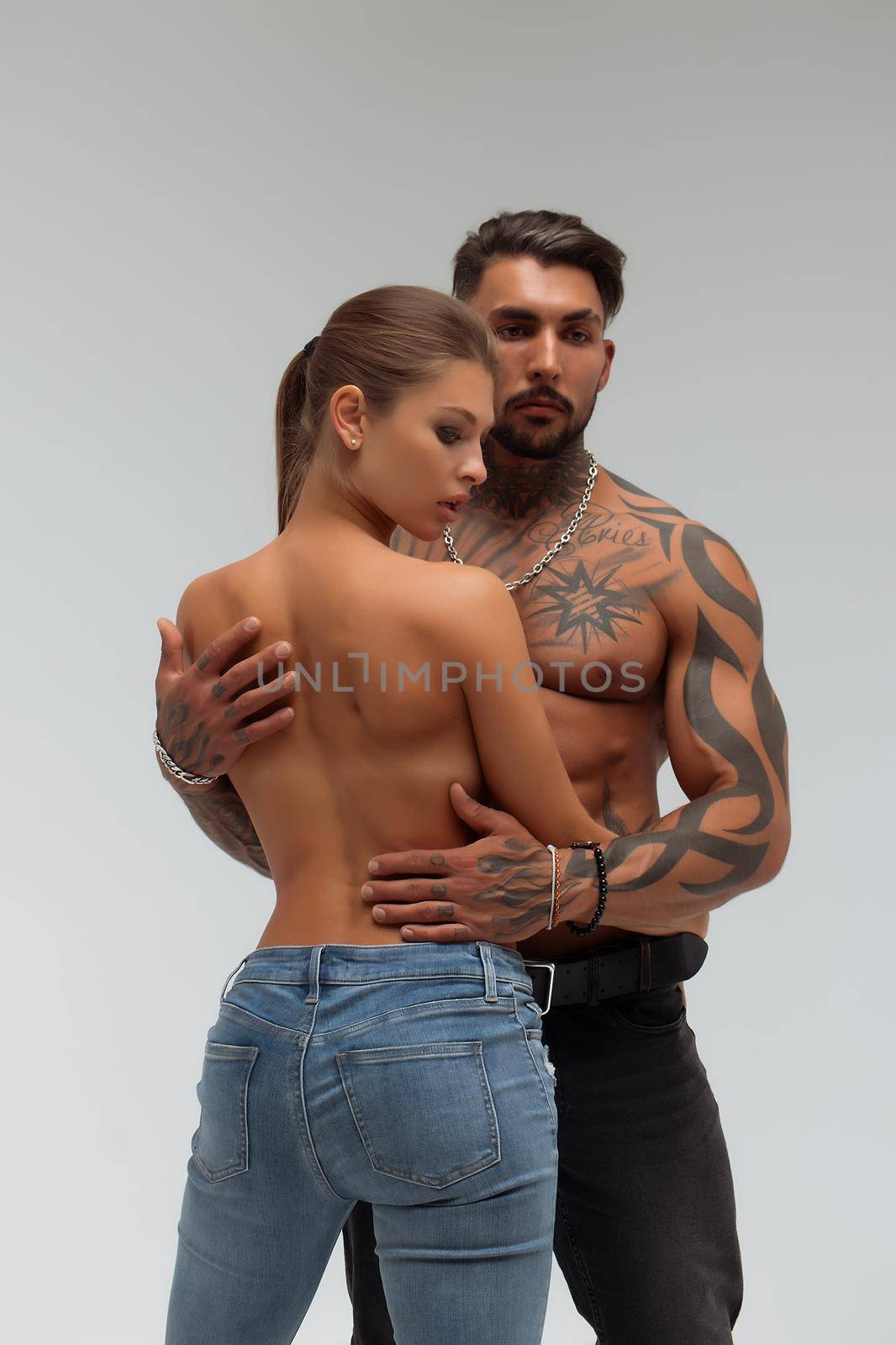 Woman hugging muscular man from behind by 3KStudio