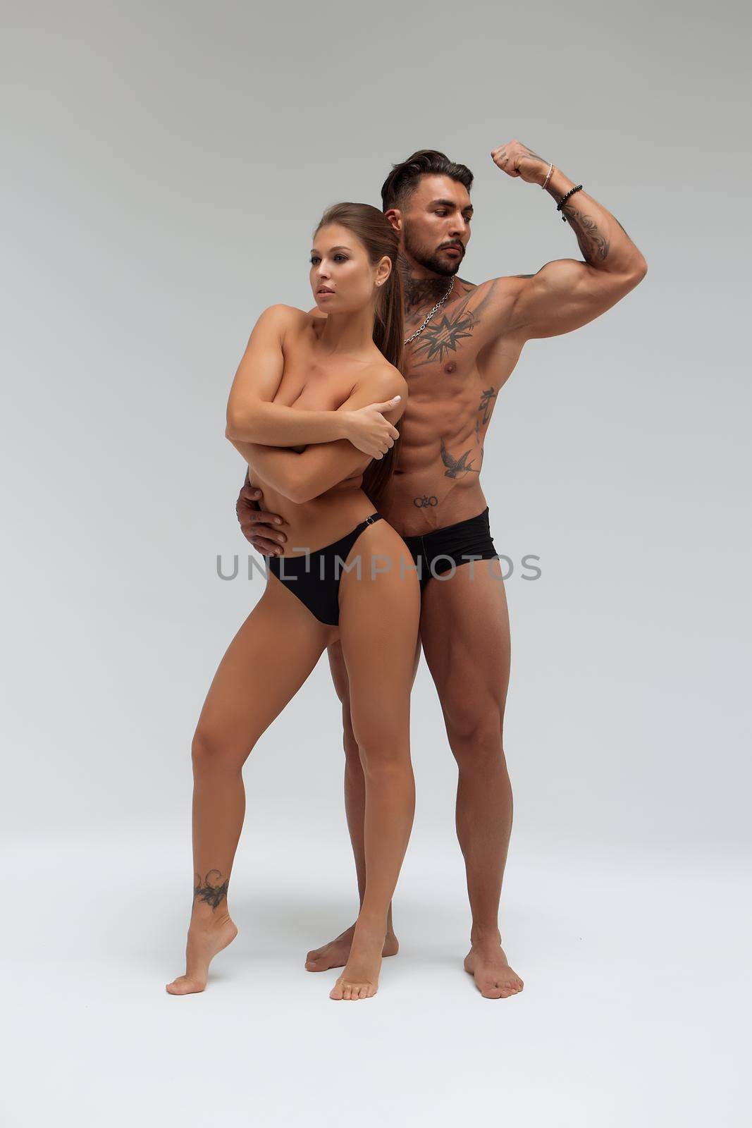 Woman hugging muscular man from behind by 3KStudio