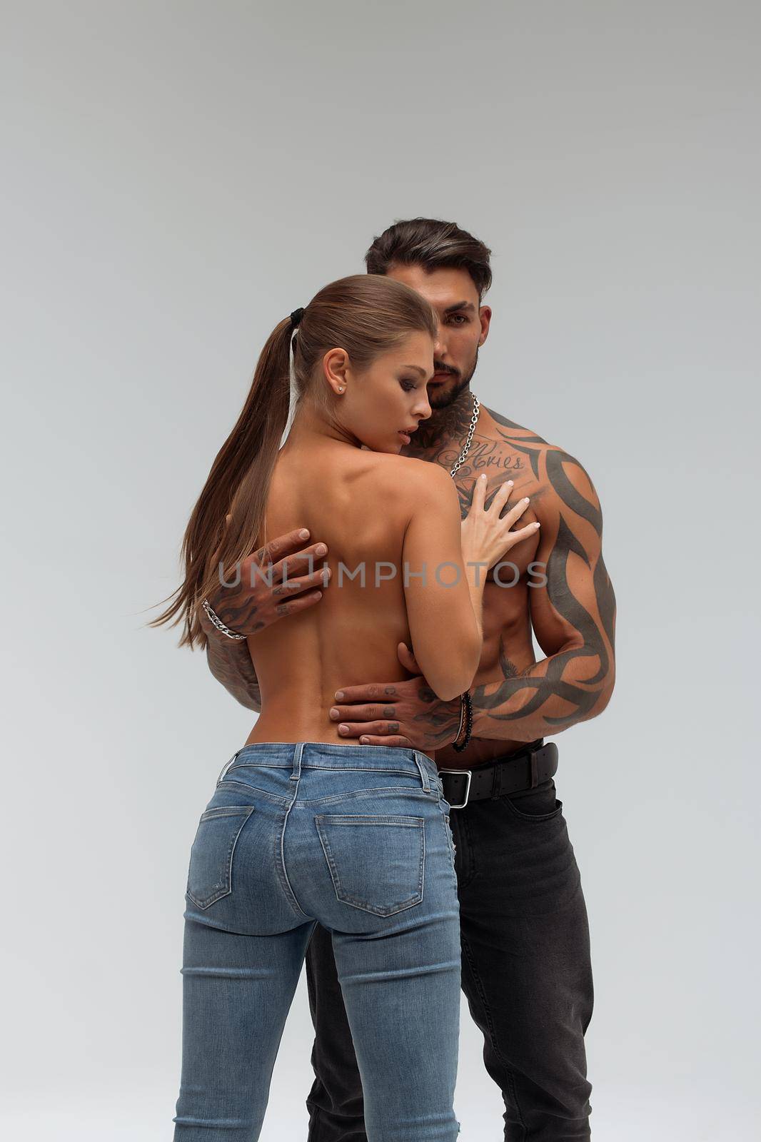 Woman hugging muscular man from behind by 3KStudio