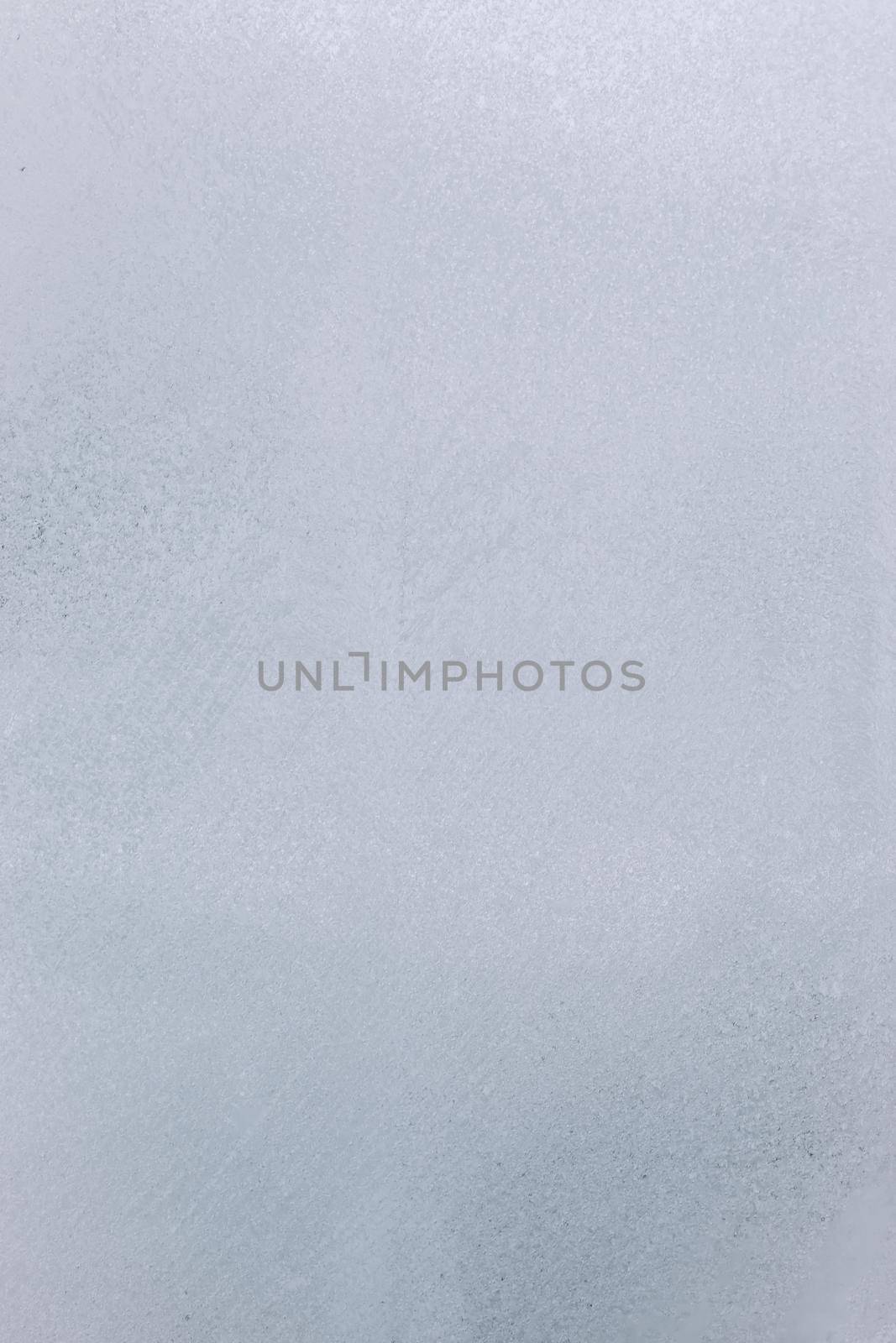 Frost patterns on frozen window. frosted glass texture.