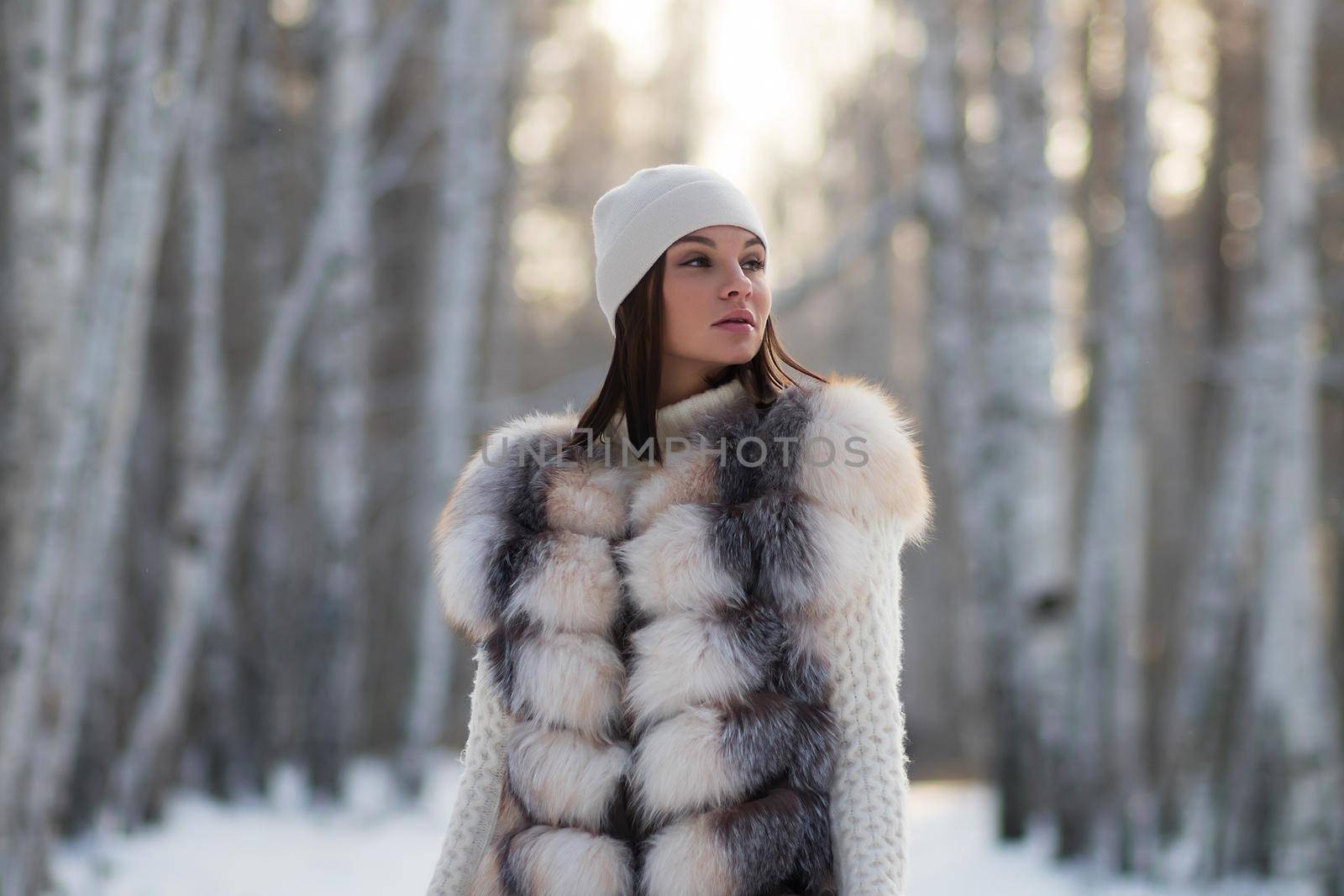 Elegant female in winter clothes in woods by 3KStudio