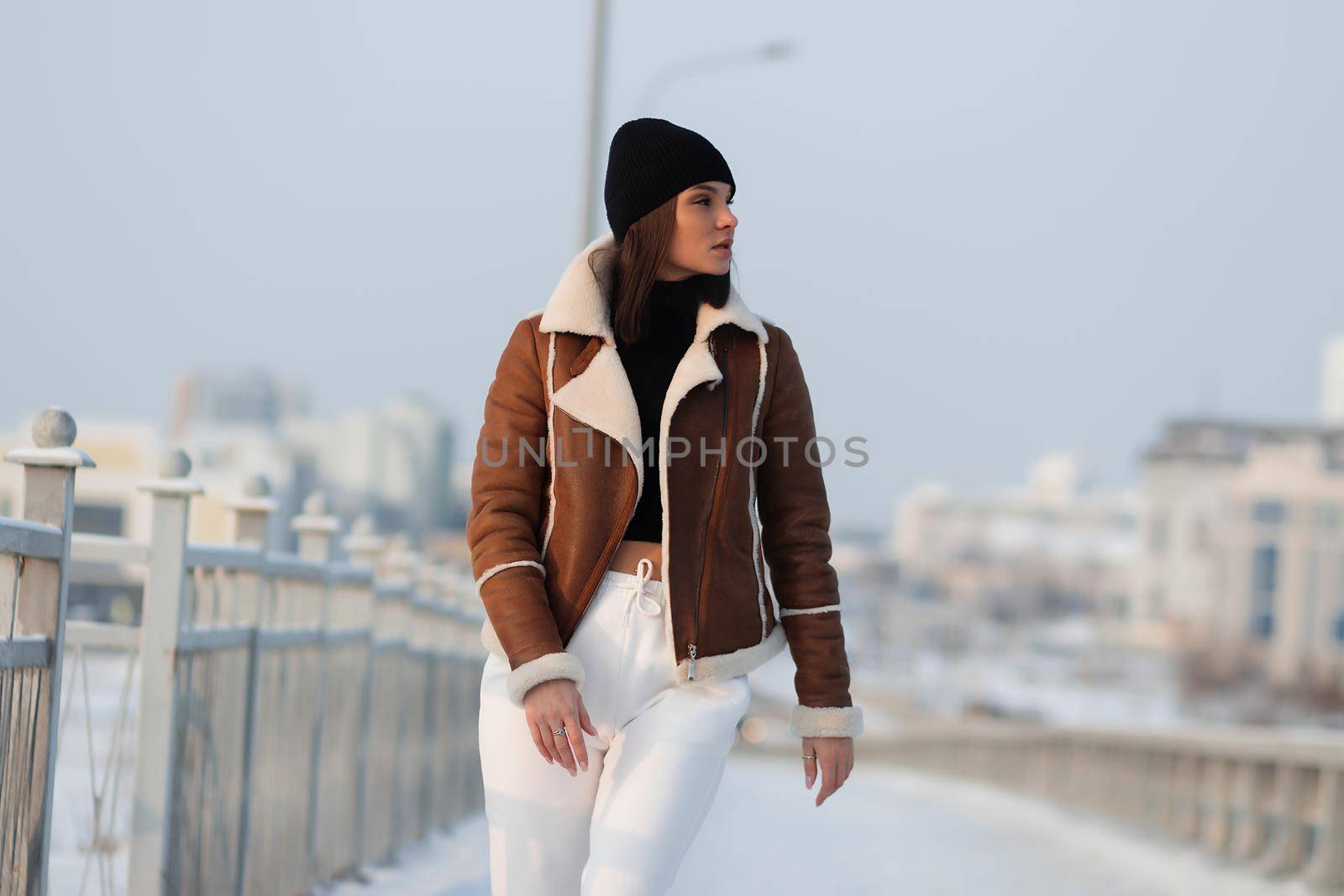 Trendy brunette in stylish winter jacket by 3KStudio