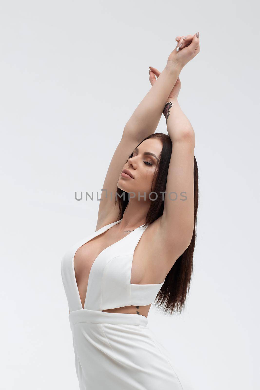 Sensual woman in sexy dress on light background by 3KStudio