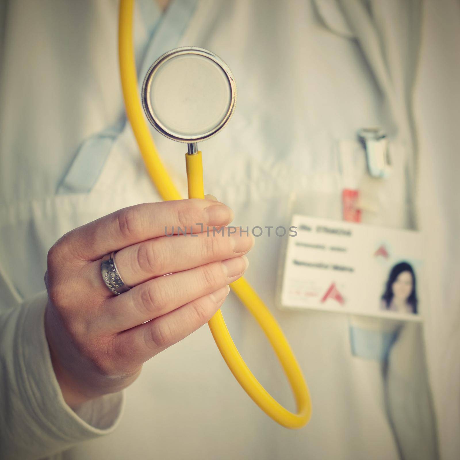 Female doctor holding a stethoscope. Concept for health and medicine. Hospital background. by Montypeter