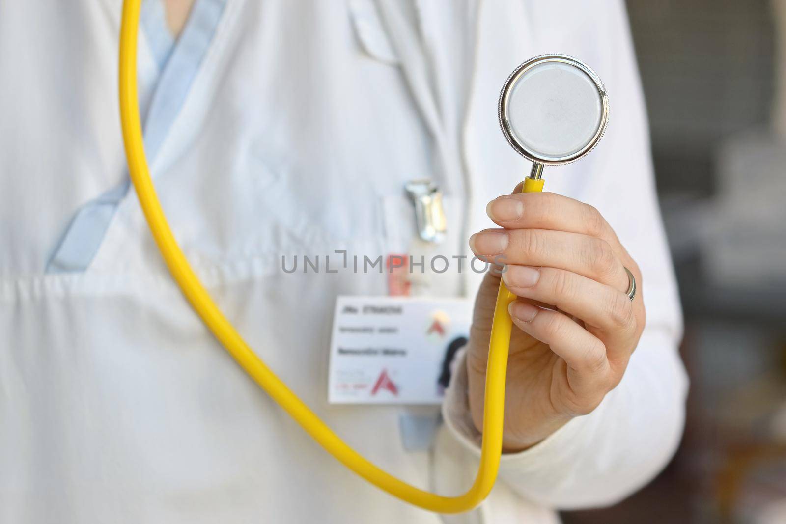 Female doctor holding a stethoscope. Concept for health and medicine. Hospital background.