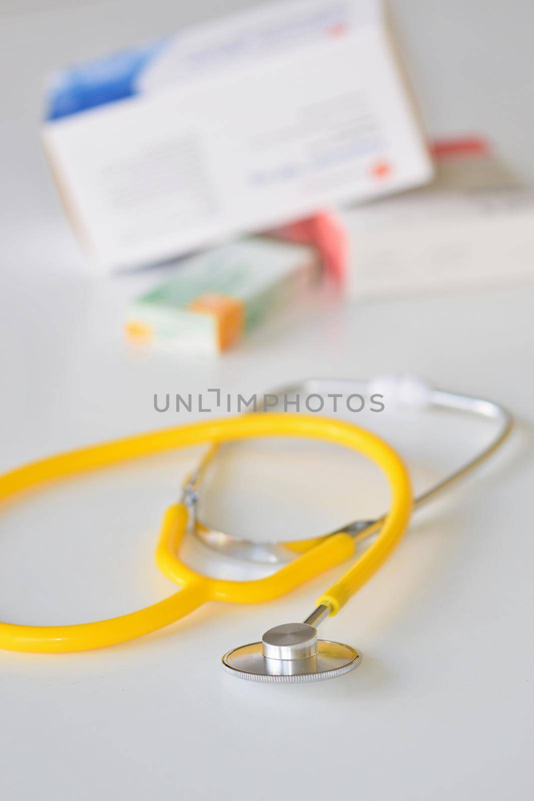 Stethoscope with medication on the table. Concept for health and medicine. Hospital background. by Montypeter