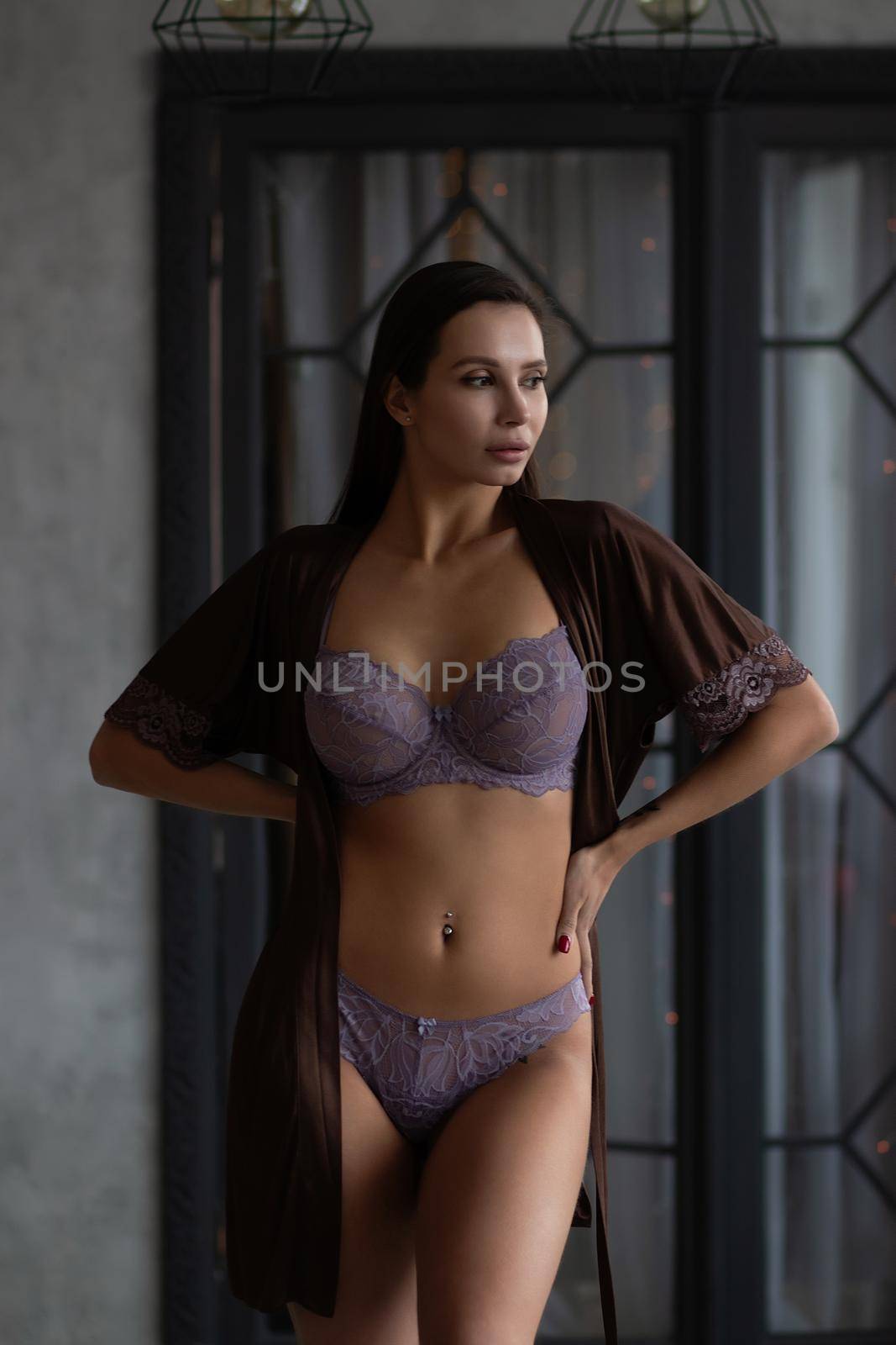 Gorgeous young female model wearing various stylish underwear during Christmas holidays at home by 3KStudio
