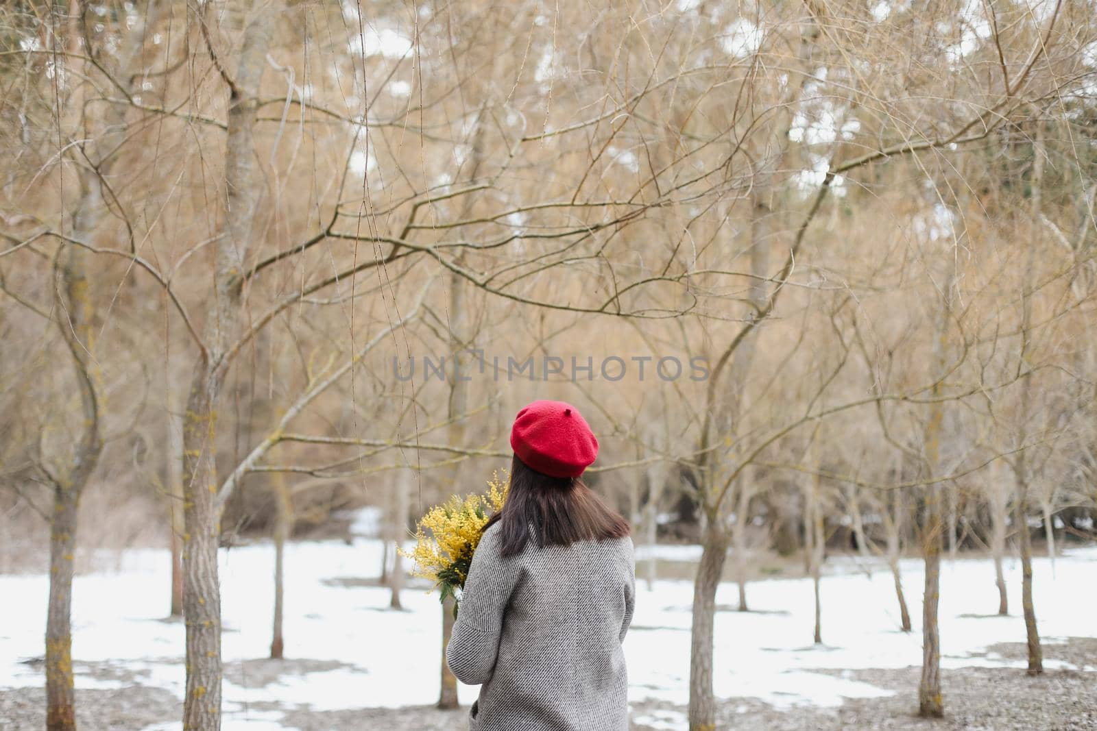 beautiful portrait of a young woman with mimosa flowers outdoors