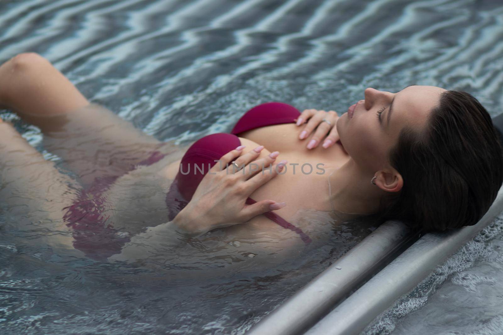 Seductive female resting in pool by 3KStudio