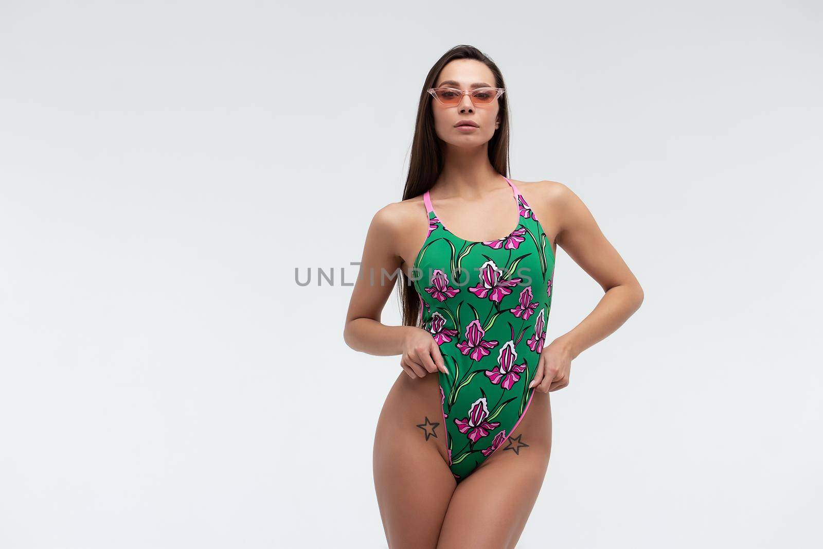 Slim woman in swimwear with sunglasses by 3KStudio